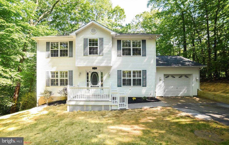 Move In Ready! This 4 bedroom 2 1/2 bath home has been freshly painted, new appliances and hardwood floors and ceramic tile in kitchen and baths. Enjoy relaxing on the large rear deck which features hand washing facilities. Additional features include master walk-in closet, washer/dryer hook-up on upper level, a walk-out unfinished basement, Plantation shutters, new roof and new front porch and walkway. Extensive yard work complete to re-arrange drainage and yard reseeded. New Granite counter tops to be installed