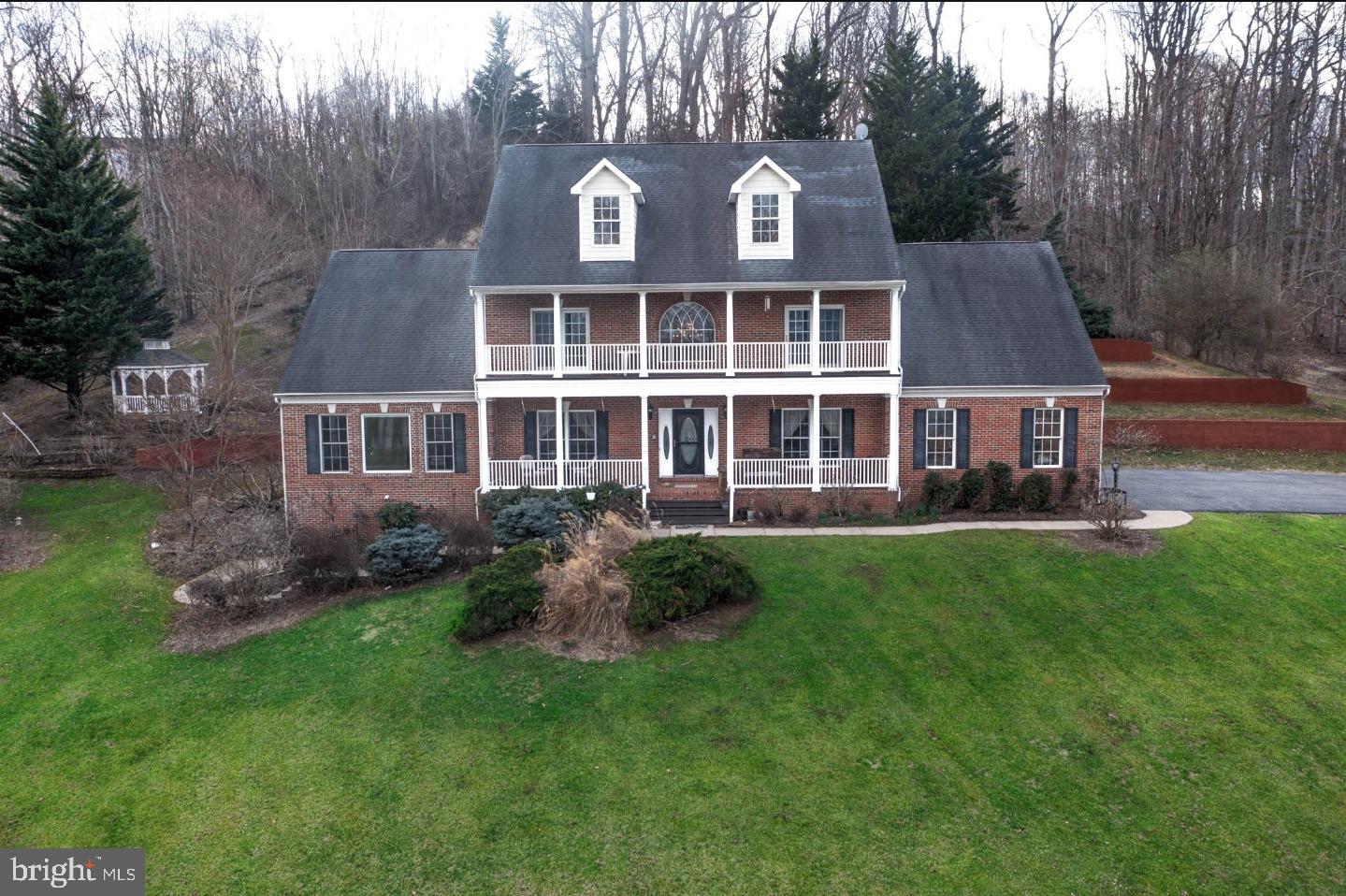 Nestled along the Potomac River and Aquia Creek, this custom-built Colonial offers a blend of elegance and historical significance. Located in an exclusive 12-home community, the property offers direct water access with a private dock, boat slip, and a boat ramp, making it a dream for boating enthusiasts.
The home boasts 9' ceilings, crown molding, and stunning views throughout, especially from the multiple verandas. The primary suite offers a sitting area, a walk-in closet, and an en-suite bath with dual vanities, a soaking tub, and a shower. Two additional upstairs bedrooms share a walk-in closet that can also serve as a play area or extra living space.
The kitchen offers an island, stainless steel appliances, and ample cabinetry opening to a grand family room with cathedral ceilings and a propane fireplace. An adjoining spacious sunroom provides a peaceful retreat with stunning river views, while the formal dining room and two main-floor flex spaces add elegance and versatility.
The finished walkout basement, pre-wired for surround sound, offers endless possibilities and includes a rough-in for a fourth bathroom. Outside, enjoy scenic walking trails, lush fruit-bearing trees, a charming gazebo, and a private park area with a fire pit, as well as panoramic river views from “Pirates Peak.”
Located just minutes from Aquia Landing Park—a site rich in Civil War history, known for its sandy beaches, pavilions, and fishing spot this home is also an easy commute to Washington, D.C., Quantico, and Fredericksburg via nearby highways and the Brooke Station VRE. This extraordinary property seamlessly blends luxury, history, and natural beauty. Whether you're seeking a serene private retreat or a stately home with rich historical connections, this is a once-in-a-lifetime opportunity to own a piece of Virginia’s treasured past and present.
**Some images virtually cleared and staged.