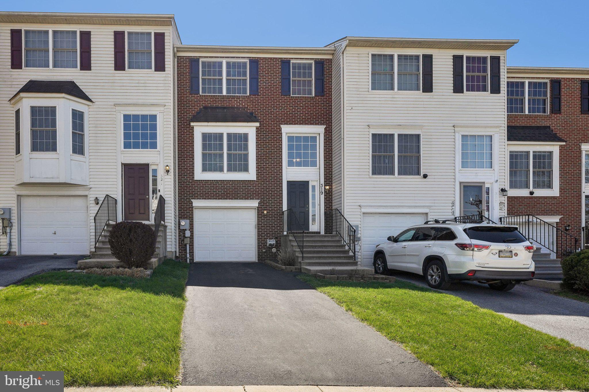 Welcome to this stunning and spacious townhome located in the sought-after Market Square community. Impeccably maintained and in pristine condition, this home features beautiful hardwood floors throughout, offering a warm and inviting atmosphere. Enter into the bright and airy main level, where gleaming new hardwood floors flow seamlessly across the open-concept living and dining area, highlighted by large windows that flood the space with natural light. The kitchen, located at the rear of the home, features brand new stainless steel appliances, new flooring and a large window overlooking the tranquil backyard. A door off the kitchen leads to the second-story deck, complete with stairs leading down to the private backyard. A convenient half bathroom rounds out the main level. Upstairs, you'll find three generously-sized bedrooms, all with beautiful hardwood floors. The rear-facing primary suite offers a serene retreat, complete with an ensuite for added privacy. The two secondary bedrooms share a full hall bath. The finished walk-out lower level provides even more living space, including a large family room with sliders leading out to a covered deck and a spacious backyard with a garden bed. The lower level also provides access to the one-car garage and includes a convenient laundry area and another half bathroom. This home is ideally located in the desirable Market Square community, offering both comfort and convenience with easy access to local amenities and transportation.