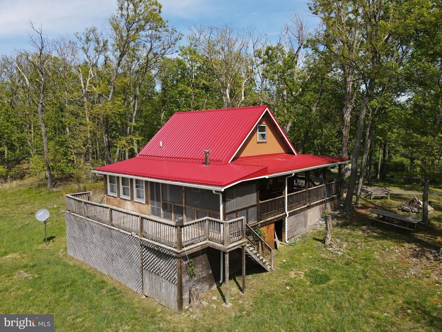 CALL NOW TO SEE THIS PRIVATE AND SECLUDED , TOP OF  THE HILL CABIN  WITH A WONDERFUL DECK AROUND 3 SIDES INCLUDING A SCREENED IN PORCH, OPEN PLAN LIVING ROOM, DINING AREA AND KITCHEN, BATHROOM , ONE BEDROOM ON MAIN FLOOR AND  A LOFT BEDROOM . THERE ARE VAULTED CEILINGS, A SKYLIGHT  FOR LOTS OF NATURAL LIGHT.  LOCATED ON TWO ROLLING AND WOODED ACRES WITH A MOUNTAIN VIEW YOU ARE AT PEACE WITH THE SERENITY OF THIS PEACEFUL VALLEY SUBDIVISION. HOME WARRANTY IS INCLUDED IN THE SALE.

 THERE HAD BEEN A SMALL POND IN THE BACK YARD WHICH COULD POSSIBLY BE FILLED AGAIN.  BRING YOUR MARSHMALLOWS, CHOCOLATE AND GRAHAM CRACKERS FOR SMORES OVER THE STONE FIRE PIT.  A STORAGE SHED IS ALSO ON THE PROPERTY FOR YOUR LAWN EQUIPMENT OR OTHER THINGS TO STORE.
IMAGINE SITTING ON THE DECK WATCHING DEER, SQUIRRELS, BIRDS, AND OTHER ANIMALS WHILE AT NIGHT YOU ARE STAR GAZING PLUS LOOKING AT THE MOON AND CONSTELLATIONS.
ONLY 3 MILES AWAY FOR SHORT MOUNTAIN WITH 8000 ACRES TO EXPLORE OR HUNT. SIMPLE COUNTRY LIVING, ONLY 2 HOURS FROM DC METRO AREA.
MOVE TO WEST VIRGINIA AND  BECOME A MOUNTAINEER!!!!!!!!!!!!!!!!!