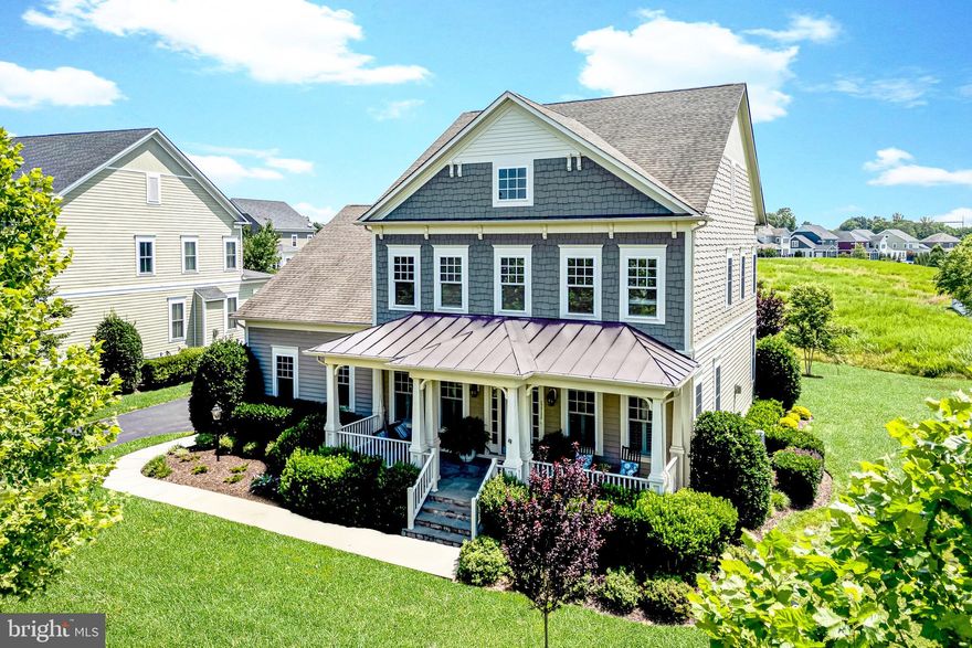 Grace and grandeur define this distinguished Chadwick model, situated serenely at the end of a quiet cul-de-sac and embraced by protected conservation land in the esteemed enclave of The Grange at Willowsford. Resting upon a meticulously maintained ¼-acre parcel, this residence offers a rare blend of peace, privacy, and refined living, all framed by the timeless beauty of its natural surroundings.
<br><br>
Upon arrival, the home's stately presence immediately impresses, with a gracious covered flagstone porch that evokes both welcome and repose. Stepping inside, one is met with a refined foyer, where formal living and dining rooms unfold on either side—each adorned with timeless moldings, plantation shutters, and wide plank flooring, all bearing witness to a meticulous attention to detail and enduring craftsmanship.
<br><br>
At the core of the residence is a beautifully appointed kitchen, where gleaming quartz countertops, elegant shaker cabinetry, and polished stainless steel appliances come together in harmonious balance. A substantial center island encourages convivial gatherings, while a thoughtfully integrated coffee bar and a spacious walk-in pantry lend both charm and practicality. Just beyond, the sunlit breakfast room opens with ease to a covered rear porch, offering a tranquil extension of the home’s living space.
<br><br>
Anchoring the main level is a handsome family room, distinguished by its shiplap accent walls and an inviting corner fireplace encased in stone—a perfect setting for intimate evenings. A private study, discreetly tucked away, offers a tranquil retreat for work or reading, while the adjacent mudroom—complete with a chalkboard wall—ensures the rhythms of daily life remain well-organized.
<br><br>
Ascend the stairs to discover a refined primary suite, accessible through double French doors and featuring new carpeting, a spacious walk-in closet, and a luxurious bath appointed with a frameless glass shower and dual vanities. Three additional bedrooms offer ample comfort: one with its own ensuite bath, and two served by a well appointed hall bathroom. A well-placed laundry room on this level adds convenience and practicality.
<br><br>
The home’s lower level unfolds to reveal a beautifully finished walk-up basement, thoughtfully designed to accommodate every aspect of gracious living. A generous recreation area, game room, and media space provide ample room for leisure and entertainment, while a private den—ideal for overnight guests—features its own ensuite bath and walk-in closet, ensuring comfort and seclusion. An abundance of storage further enhances the versatility of this expansive level, offering both function and flexibility for the discerning homeowner.
<br><br>
Outdoors, a covered rear porch and patio extend the living space amid lush greenery, supported by an eight-zone irrigation system that keeps the grounds verdant throughout the seasons. A side-load two-car garage completes the offering with quiet distinction.
<br><br>
Willowsford stands as Northern Virginia’s premier residential community, offering a truly distinctive way of life inspired by natural beauty, sustainability, and a deep-rooted connection to the land. Encompassing 4,000 acres of thoughtfully preserved countryside, this masterfully planned enclave comprises four unique villages, each nestled amidst open meadows, verdant forests, and working farmland stewarded by the Willowsford Conservancy. Residents are afforded an exceptional array of amenities, including Sycamore House and The Lodge at Willow Lake—elegant gathering places that feature resort-style pools, state-of-the-art fitness centers, and farm-to-table culinary experiences. A robust trail network, scenic fishing lake, amphitheater, dog park, and nature-inspired recreational areas further enrich the vibrant and purposeful lifestyle that defines this extraordinary community.