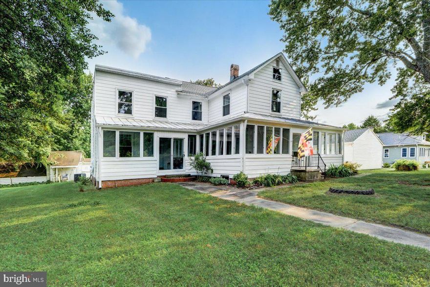 Welcome to water country. Located in the Rural Legacy area on the Lower Back River Neck Peninsula & water oriented community marinas within walking distance. Lots of updates for this 2+ acre home: this meticulously owned 4 bedroom 2 bath home features many things especially: a huge eat-in kitchen and wrap around enclosed porch- newer LVP floors on the main level with large sized rooms. Original features include: tin ceiling in Kitchen, moldings & some doors. Kitchen adjoins a FR area or could be eating area. Updated entire roof and roofing structure - newer windows approximately 3 years old. Gutter guards/ 2 zoned AC/Heat. Detached garage and shed/greenhouse-great for chickens or other. Mechanicals serviced every year- great property-come check it out!