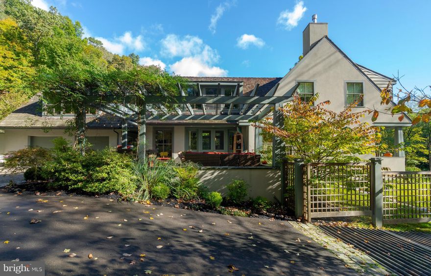 Situated on one of the most coveted roads in Bucks County, this exquisite contemporary cottage exudes a sophisticated elegance. No detail or refinement was overlooked when custom builder Jarrett/Vaughan constructed this architect- designed jewel. Exceptional workmanship and high quality materials were used throughout.  The main level is an open concept entertainers dream- large windows for an abundance of natural light, radiant heat in the walnut floors, gas fireplace with stone mantel and easy access to outdoor terraces and porches. The gourmet kitchen with high-end stainless appliances, custom Maple cabinetry, huge island, sitting area and butler's pantry is sure to please the most discriminating of chefs. Also on the main level, a private master suite with vaulted ceiling, walk-in closet and limestone bath, opens to it's own private courtyard garden. Upstairs you'll find a loft/seating area and two additional bedrooms and two full baths, one ensuite.The hallway leads to a bonus room, a large hall closet and an amazing light-filled artist studio/office space with vaulted ceiling, built-in cabinets and window seating. There is an outside entrance from the office to another lovely sitting area with views of the hillside.  State-of-the-art geothermal heating and air conditioning systems provide comfort and efficiency. This is the Bucks County property that one cannot afford to miss.