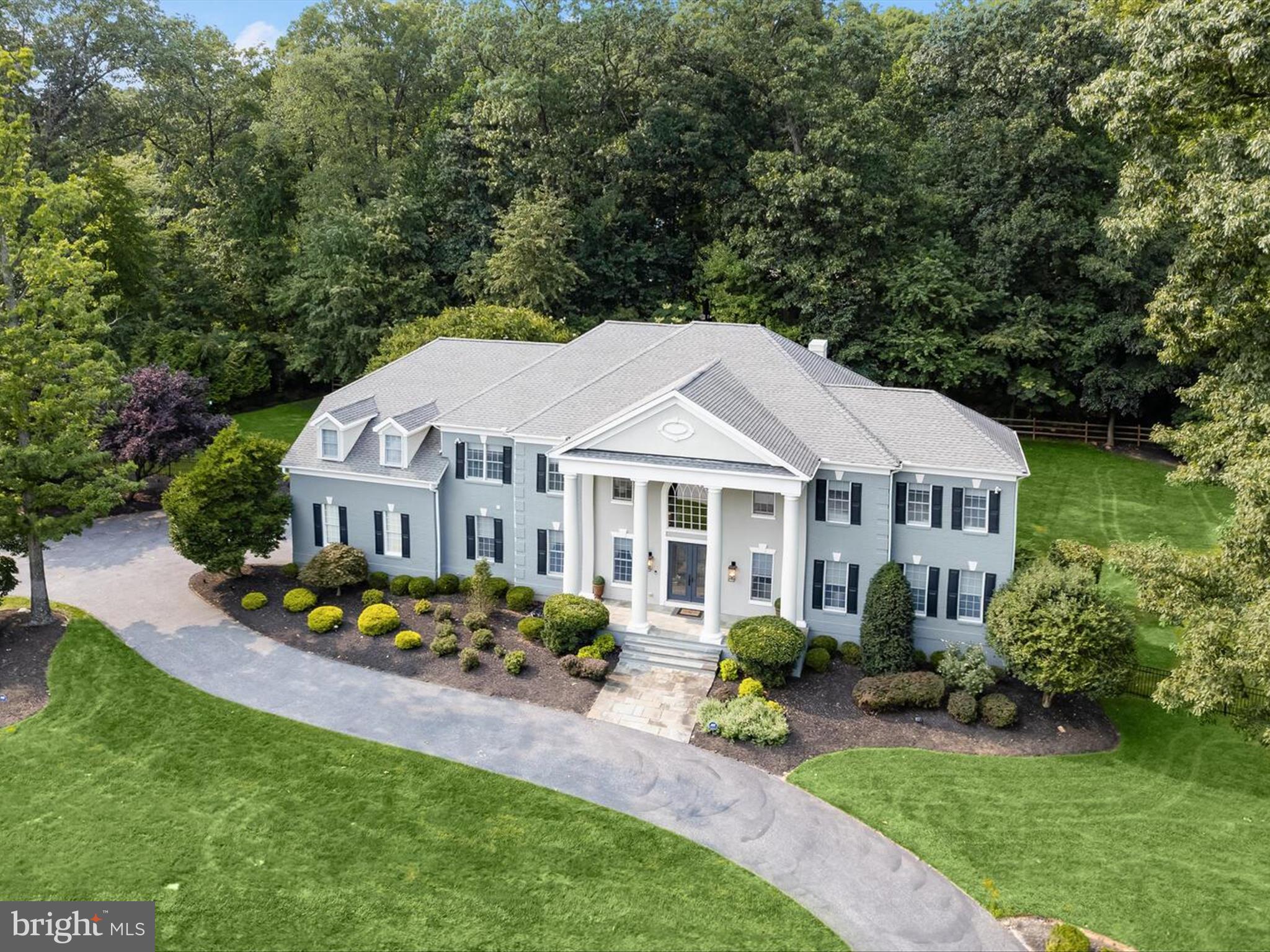 Georgian Architecture Meets High StyleÂ
This gated, resort-styled property is located on a premium cul-de-sac lot in the beautiful community of Caves Forest Estates.
Recently upgraded with the finest upscale designer details inside and out, this like-new property is simply impeccable in every way. Situated atop a hill, this property presides elegantly over two acres with lush front, side and rear lawns. At the center of a circular drive the grand Georgian exterior architecture celebrates arrival with a covered front porch and soaring monumental columns. A pair of commanding eight foot double entry doors welcome guests into a storied foyer with a dramatic staircase embellished with upgraded iron balusters and a new and stylish aesthetic. The center foyer is sided by living and dining formals with gleaming hardwood floors that become a unifying design element along with exquisite designer lighting at every turn. A fresh design aesthetic is established and is carried throughout the main and upper levels.The open living room is spacious and features an extended area perfect for fine indoor entertaining. An equally tasteful and open formal dining room offers a stunning designer chandelier and an adjacent butlers service pantry.  Central to the graceful open floor plan is the two story great room bathed in light from clerestory Paladian windows and a coffered ceiling articulated with a grand gesture. A cozy gas fireplace and tall wood mantle is elevated with an over-mantle of understated, yet lofty panel molding.Adjacent to the great room on one side is a regal powder bath and an elegant work-at-home office or study accessed through a pair of private french doors. On the other side of the central great room is a gourmet chef's kitchen outfitted with professional stainless appliances, pot filler, a wrap-around island, prep sink and breakfast bar. Extensive cabinetry, wraps the perimeter and two pantry closets are close at hand. The eat-in kitchen and breakfast room offer access to an outdoor patio with a gas cook station and built-in firepit surrounded by outdoor living and entertaining spaces under a dramatic pergola. Inside, the kitchen seamlessly opens to a mud room, full bath and secondary stair that rises to four upper level ensuite bedrooms, and a conveniently located laundry center. A well-appointed primary bedroom suite is luxuriously finished with a double tray ceiling, strong crown, and cove lighting in the bedroom ceiling, and a second double tray ceiling in the private sitting area outfitted with a gas fireplace, wine fridge and coffee bar. Still to come is a spa-like lux bath with two generous and separate vanities, a walk-in shower clad in designer tile, and a sumptuous jetted tub. Extensive walk-in closets complete the primary suite and will accommodate the most cultivated wardrobes, shoe collections and storage. Â
Downstairs, a conveniently located wet bar wraps a kitchenette with custom cabinetry, a sink and a full size fridge ready to service the recreation area, game area and theater with reclining seating for eight. The lower level is also equipped with an impressive exercise room finished with rubber floor and mirrored walls for the most discerning athlete, as well as a very special dog room for your favorite furry family pet. The fully finished lower level is completed by a fifth bedroom, full bath, storage room, and a double slider door with a walk-up exterior stair.
There are endless upgrades with incredible detail that include remote blinds in every bedroom, designer tile in every bath, and up-to-the-minute finishes in soft neutrals that will be pleasing with any palette throughout this luxury residence. Come home to this very special property with a rare opportunity to move right in and enjoy a superbly renovated, tasteful, and immaculate home with resort-style inside and out.