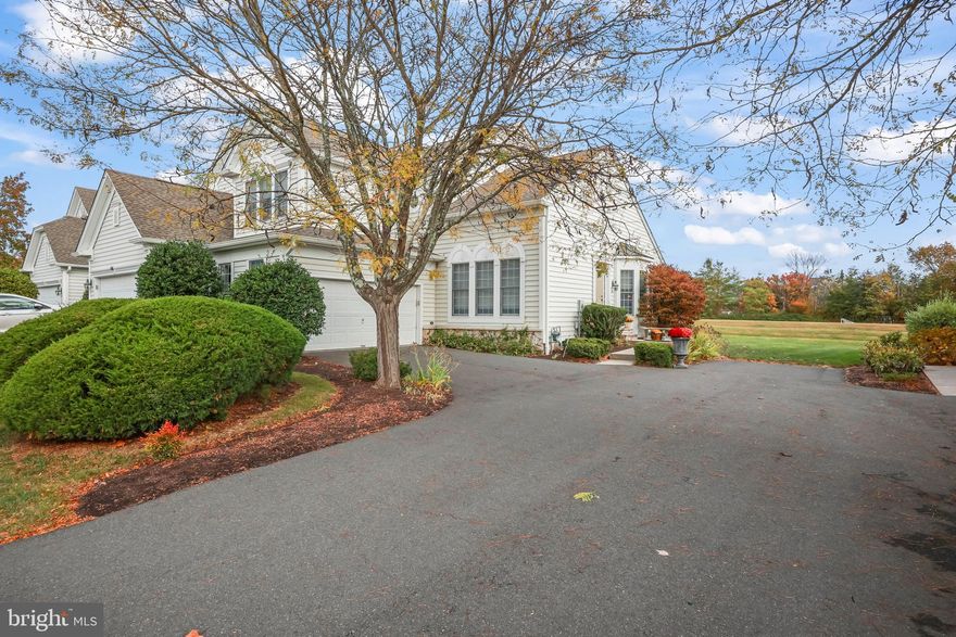 Fieldwood Manors • 10 min to Downtown Princeton • End unit with 2-car garage • First-floor primary suite • Open kitchen and family room with fireplace • Finished basement with full bath • Fenced paver patio backing to open space. Located in the desirable Fieldwood Manors community, this 2,350 sq ft end-unit townhome blends classic style with comfortable living just minutes from Princeton University and the cultural amenities of downtown Princeton. A welcoming foyer opens to a formal living room and dining room accented by a walk-in bay window, hardwood floors, and crown molding. The kitchen offers granite counters, tumbled-stone backsplash, stainless-steel appliances, white cabinetry, and a peninsula for casual seating. It flows seamlessly to the dining area and family room with a gas fireplace, creating an inviting open-concept layout ideal for everyday living and entertaining. Sliding doors extend the living space to a fenced paver patio, perfect for al fresco dining and quiet relaxation. The first-floor primary suite provides a peaceful retreat with a soaking tub, separate shower, dual-sink vanity, and private water closet. Upstairs, two bedrooms share a Jack-and-Jill bath, while a flexible loft offers space for a home office, play area, or creative studio. The finished basement expands the living area with a full bath, an additional below-grade guest room, and abundant storage. Set on a 0.13-acre lot backing to community open space, this home includes an attached two-car garage. Within the highly rated Princeton Public Schools district and near several of the area’s most respected private schools, this home combines low-maintenance living with timeless Princeton appeal in one of the region’s premier townhome settings.