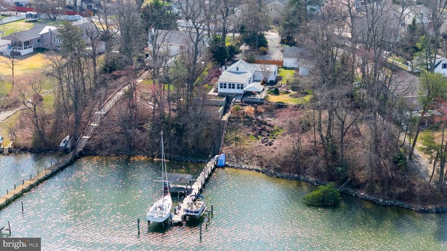*****OPEN HOUSE - SUNDAY, 3/29 FROM 2-4 PM ****. Don't miss this opportunity to own a deep water waterfront home on Stony Creek - Close to the Patapsco River!!  

Fully renovated in 2019, this wonderful waterfront ranch offers over 198' of deep water frontage (bring your sail boat) and the perfect blend of modern comfort and serene coastal living. Featuring 3 bedrooms and 3 full baths, the open floorplan is thoughtfully designed to capture stunning water views from the main living spaces.

The bright white galley kitchen with crisp cabinetry flows seamlessly into the spacious living and dining areas, making entertaining effortless. A charming wood stove adds warmth and character, creating a cozy focal point while maintaining the home’s clean, updated aesthetic.

Step outside to your private outdoor oasis. The covered deck overlooks the water—ideal for morning coffee or sunset gatherings. A tranquil 5,000-gallon koi pond provides a peaceful setting perfect for relaxation and meditation. Boating enthusiasts will love the private deep-water pier equipped with a 16,000-pound double I-beam sailboat lift, a 12,000-pound pontoon boat lift, and the original covered area for added storage and charm.

Additional highlights include an oversized 2-car garage offering ample space for vehicles and storage, plus an Amish-built 12x24 shed for even more versatility. Situated on a private lot with a quaint fenced area, this remarkable property delivers the ultimate waterfront lifestyle with privacy, functionality, and timeless appeal.