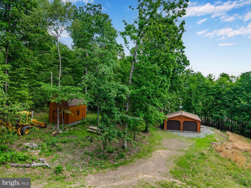 A rare opportunity to enjoy 10 wooded acres with the potential for a future full-time residence or private mountain retreat. Zoned residential and located along a quiet private drive with a mix of year-round homes and seasonal cabins, this property offers flexibility that’s hard to find in recreational land. Perc and probe testing is underway, adding to the appeal for those seeking a future homesite surrounded by nature. 

The property is already set up for immediate enjoyment with a barn-style structure featuring a sleeping loft, detached garage with electricity, wood stove with newly cleaned chimney, A/C unit, bunk beds, sofas, and a kitchen prep area with sink ready for hookup. Outside, enjoy the immediate benefits of a port-a-potty, picnic table, fire pit, and included backhoe. 

Directly across from Bald Eagle State Forest and conveniently located near Reeds Gap State Park, Poe Valley State Park, Penn’s Cave, Woodward Cave, Thousand Steps Trail, and Juniata River recreation. Just 45-minutes from Penn State University. Peaceful, private, and packed with potential!