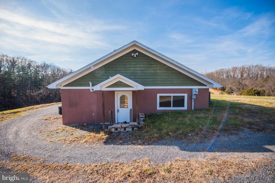 Unique!!! House sit beautifully on over 8 unrestricted, private acres. Mountain views east and west and your own pond! The house is move in ready with solar water eater, radiant heated floors, open floor plan and windows, windows, windows. Bright and cheery, wood stove makes it cozy on cold nights. Separate studio/storage building on property, bring your ideas!