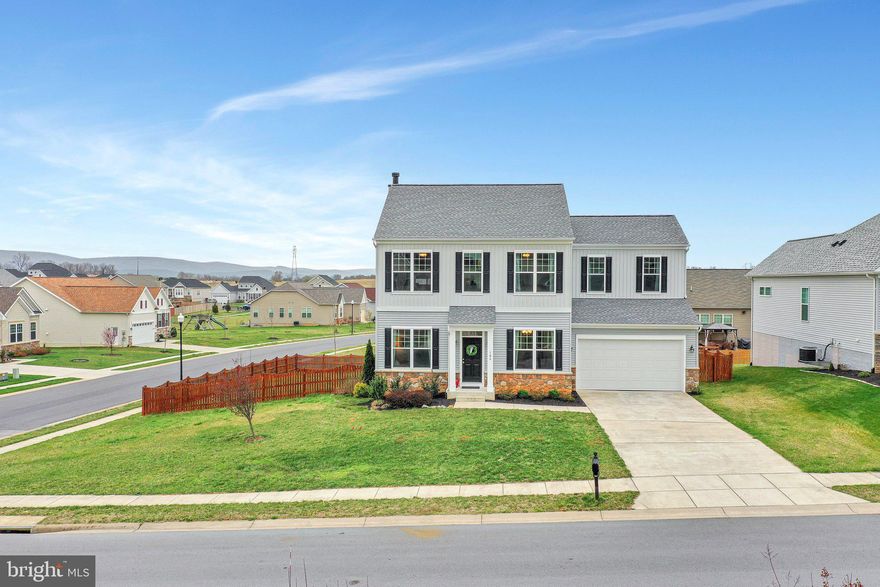 This gorgeous colonial has all the features you've been looking for: tall ceilings, attached two-car garage, wood burning fireplace, granite countertops in the kitchen, and ceiling fans in every one of its five bedrooms. Built on a corner lot with a fenced in yard and great views of the mountains in the distance. Four bedrooms upstairs, including the deluxe primary suite with large walk-in closet, soaking tub, and dual sinks. This home is move-in ready, with fresh paint and new carpet. The finished basement contains a bedroom and full bathroom along with a family room. In the back, you'll find a deck and patio, perfect for grilling this summer. And to top it off, this home is in Norborne Glebe, a beautifully landscaped neighborhood with lots of common space, conveniently located directly off of 340 just outside of Charles Town. Just fifteen minutes from Harpers Ferry and within easy driving distance of Winchester, Leesburg, and Frederick, and more. Schedule a showing or attend the open house on 4/10 from 1-3 PM!