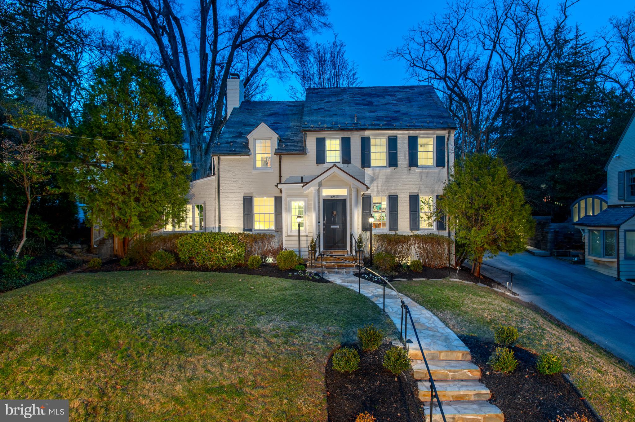 Just steps from Glover Archbold Park, this property offers a tranquil retreat while remaining conveniently close to the hustle and bustle of Georgetown and downtown DC. Upon entering the foyer, one has a view into each of the main rooms of the home. To the left, the spacious living room awaits, complete with a fireplace (currently wood-burning, previously gas). An inviting sunroom sits just behind the living room, perfect for relaxing on warm afternoons.
The dining room easily accommodates 12 or more guests and has large windows that flood the space with natural light. The kitchen is a true highlight with its distinctive design, featuring an exposed brick wall, a glass tile accent, and high-end appliances, including a Sub-Zero fridge, Wolf stove, and Bosch dishwasher. It also features a kitchen island and space for a breakfast nook in the corner. One cannot miss the unique powder room, featuring a stunning Turkish marble sink.
The kitchen and sunroom both lead to a stone terrace, which serves as a fantastic extension for entertaining. A flight of stairs ascends to the pool-sized upper terrace, equipped with electric outlets and adjacent to a grassy patch, ideal for lawn activities or enjoying the outdoors. The possibilities are endless on this 11,000+ sq ft lot.
Upstairs, the spacious primary bedroom offers a generous walk-in closet, built-in shelves, and an elegant en-suite bath with dual sinks and a smart mirror. Three additional bedrooms share a well-appointed hall bath, while the third level is divided into a large bedroom and a storage room, offering even more living space.
The lower level is a functional and versatile space, with a set of stairs featuring built-in hooks for coat storage. The family room includes a wet bar with a beverage cooler, a full bath, and ample cabinetry. You’ll also find a convenient laundry room with LG appliances, a utility sink and additional storage.
Additional features include a driveway that spans from the street to beyond the home. It provides access to and from the kitchen, basement, and front door, offering ample parking. The home is also equipped with Legrand adjustable lighting, a Honeywell Pro Series thermostat and extensive outdoor lighting for added convenience and comfort.
