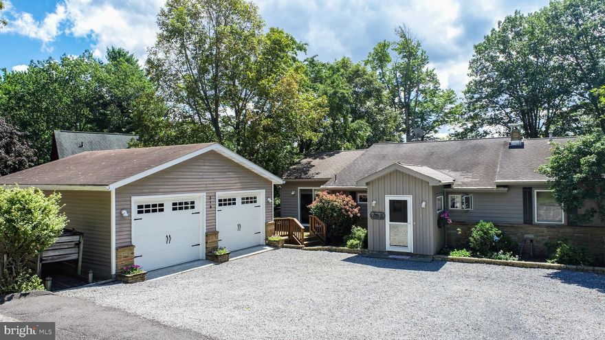 With 6 bedrooms, 5 bathrooms, and nearly 4,000 square feet of beautifully finished living space, this renovated and expanded home offers an unparalleled waterfront lifestyle along 100 feet of coveted flat lake frontage. Vaulted ceilings with exposed wood beams elevate the main living areas, highlighted by a striking wood-burning fireplace with a custom hand hewn wood mantle from an old barn, and hand picked stones by the owner from a local quarry.

The open kitchen boasts custom built-ins and high-end newer appliances (refrigerator 2023, stove 2023, dishwasher 2024), while the serene primary suite features custom built-ins, walk-in closet and seamless access to an expansive  private deck with sweeping lake views. 

Enjoy 4 bedrooms and 4 bathrooms on the main floor and a spacious walkout lower level with 2 bedrooms, 1 bathroom enhances the home’s versatility with abundant space for entertaining and guests. The lower level also features a pot belly wood stove, an abundance of storage space and access to the professionally landscaped 0.57 acre lot with gorgeous lake views. 

Designed for both luxury and leisure, the property includes a Type A dock, wave runner ramp, hot tub,  ductless AC system (2023) and a detached expanded two-car garage with 110 and 240 volt outlets.  Every detail reflects quality and craftsmanship, making this an extraordinary lakefront retreat. 

The location is on a quiet dead end street and you are less than 5 min drive to Arrowhead Market, the famous HoniHoni Bar, Unos Pizza and a short boat ride to The Creamery Ice Cream store! Welcome home to lakefront living at its best.