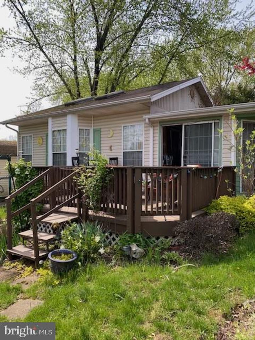 Check out this River Bend camper with 1 bed, 1 bath, an addition and an additional lot! The home has a living room and dining room with gorgeous new flooring and a fireplace! Enjoy some natural light in the sun room or a quiet hideaway in the loft. Relax and enjoy fun for all including swimming pools, miniature golf, playground, basketball hoops, tennis courts, baseball field and horseshoes. Bring your boat for water activities.  A nice sized deck for you to sit and overlook the additional lot that conveys. Electric, Water, Sewer and Trash are included in the Riverbend Membership Corp. Only an hour from the Greater DC area.