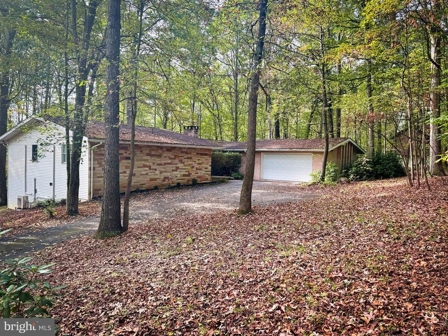 This charming 4 bedroom, 3 bath home is nestled on a peaceful wooded lot offering the perfect blend of tranquility and convenience. Located in a desirable neighborhood close to local amenities, a short drive to Raystown Lake and minutes to a golf course, this property provides both comfort and accessibility. The spacious rooms and an efficient layout create a warm and inviting atmosphere.  The main level family room offers an abundance of natural light, a brick fireplace, and built-in bookshelves. There is a place for everything with large closets and storage areas throughout the home.  The finished basement expands the living area with a cozy family room highlighted by a beautiful stone fireplace, an additional bedroom, a half bath, and a laundry area. A walkout leads directly to the patio, perfect for entertaining or relaxing outdoors.  The large eat-in kitchen with a wall pantry is the perfect combination for entertaining family and friends.   A formal dining area extends the space and opens to the serene screened-in porch, ideal for taking in the peaceful surroundings and crisp fall evenings. With its spacious layout, wooded setting, and convenient location, this property is a rare find that combines comfort, charm, and natural beauty.  Come take a look!!