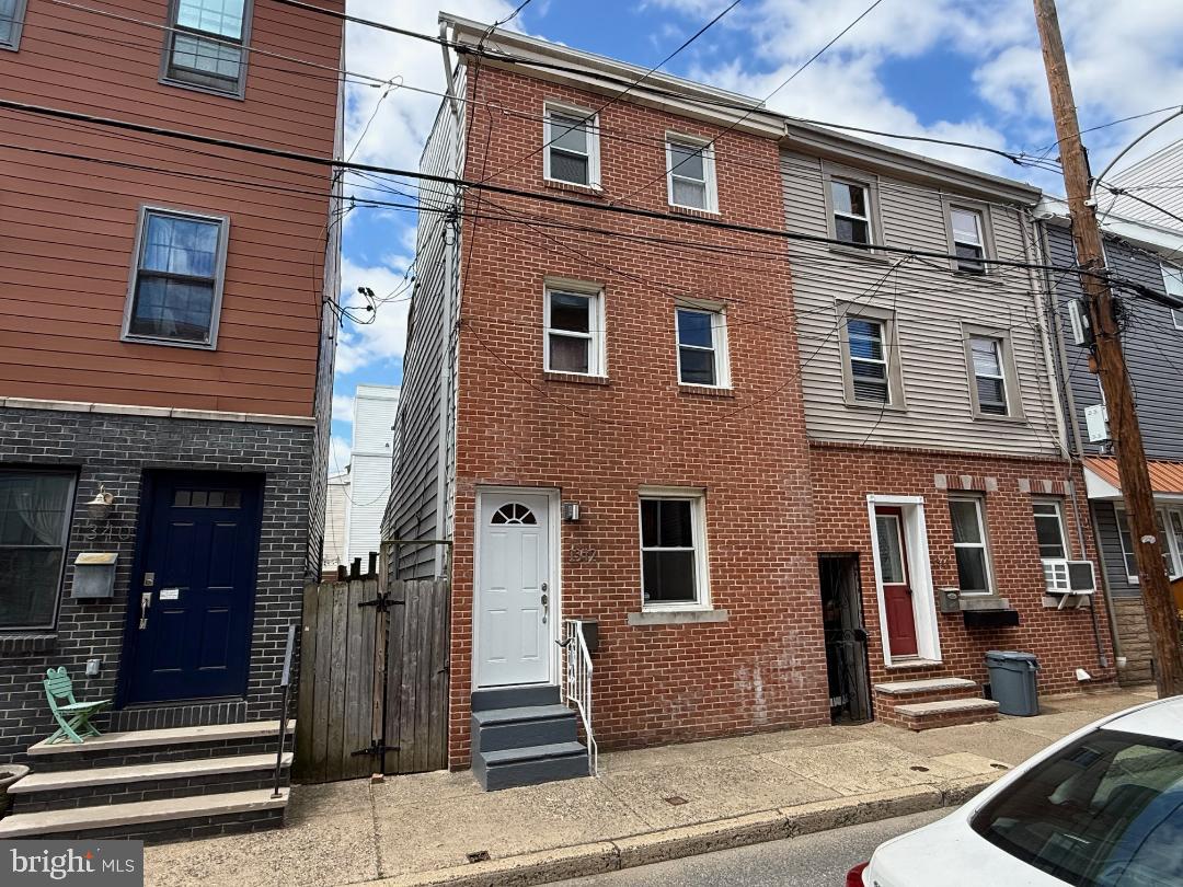 Situated on a quiet block in the heart of Fishtown, this recently renovated home offers a serene living environment while being incredibly close to the vibrant neighborhood amenities. This charming 3-bedroom, 1.5-bathroom residence offers approximately 1,200 square feet of living space spread across three floors, along with an unfinished basement that provides ample storage options. The home has been thoughtfully updated with new wood flooring and a fresh coat of paint throughout, enhancing its modern appeal.
The layout is both comfortable and functional, featuring a kitchen that is separated from the living and dining areas to create a private and efficient cooking space. The kitchen opens to a decked, fully-fenced backyard, perfect for outdoor relaxation and entertaining.
The main floor’s open-plan design seamlessly combines the living and dining rooms, and includes a convenient half-bathroom, ideal for guests and daily use. On the second floor, you’ll find two cozy bedrooms and a full bathroom. The third floor features an additional bedroom with direct access to a private deck, offering a tranquil retreat.
Located just blocks away from some of Fishtown’s finest dining and coffee establishments, such as Bastia Fishtown, Tulip Pasta & Wine Bar, and Reanimator Coffee, this home perfectly balances modern convenience with the vibrant lifestyle that Fishtown has to offer. Ideal for commuters, the property boasts easy access to major highways, numerous bus routes, and bike stations, making travel a breeze