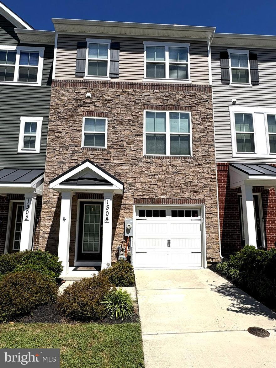 Modern 4-Bed, 3.5-Bath Townhome in Riverwalk at Crofton – Zoned for Blue Ribbon Schools Welcome to this beautifully maintained, three-story townhome in the sought-after Riverwalk at Crofton community. Just five years young, this spacious 4-bedroom, 3.5-bath home offers modern living with an open-concept design and is zoned for top-rated Crofton Woods Elementary, Crofton Middle, and the brand-new Crofton High School. The main level features a bright and airy floor plan that flows seamlessly from the living room into the contemporary kitchen and adjoining dining area. Entertain with ease in the chef’s kitchen, complete with granite countertops, stainless steel appliances, a center island, and peninsula with bar seating. Step outside onto the maintenance-free deck—perfect for outdoor dining or relaxing. The lower level offers a versatile ensuite bedroom that can function as a guest suite, in-law space, or additional family room. Step out to a small backyard that opens to community green space and a play area. Upstairs, the primary suite includes a private bath and WIC, along with two additional bedrooms, a full bath, and a convenient upper-level laundry room. Enjoy quick access to Route 3, 32, and 50—ideal for commuting to DC, Fort Meade, or Baltimore. Nearby shopping and dining at Waugh Chapel, plus favorites like Wegman’s, Aldi, and Ashling Kitchen, offer everyday convenience. This stylish and turnkey townhome offers comfort, location, and lifestyle—all in one. Don’t miss your chance to call it home!