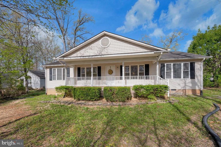 Nestled within the amenity-filled Lake of the Woods community, this ranch-style residence built in 2003, boasts a thoughtfully designed open floor plan that seamlessly connects the living, dining, and kitchen areas, creating an inviting atmosphere for both relaxation and entertaining. Step inside to discover a warm and welcoming interior adorned with rich hardwood flooring throughout living areas. The kitchen features an eat-in area, ideal for casual dining, while the combination dining/living space is perfect for hosting gatherings. The primary suite is complete with a large walk-in, tiled shower.  The second bathroom features a walk-in jetted soaking tub for a spa-like experience at home. The outdoor space is set on a partly wooded corner lot that provides both privacy and natural beauty. Enjoy serene moments relaxing on your front porch while taking in the beautiful scenery.  The community amenities elevate the lifestyle, featuring a clubhouse, fitness center, and a variety of recreational facilities including tennis courts, a golf course, and community inground pools. For those who appreciate convenience, the attached side-entry garage and ample driveway space provide easy access and parking. The property is also equipped with essential appliances, including a dishwasher and electric oven/range, ensuring that daily living is both comfortable and efficient. With this home's blend of features and a vibrant community atmosphere, it offers you a lifestyle that invites the creation of lasting memories.