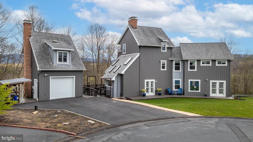 OPEN HOUSE - Sunday, April 26th, 12:00 - 1:30 PM.
Introducing a truly exceptional gem in Nittany Orchard, where contemporary design meets a 
distinctive rustic edge. You’ll love the blend of reclaimed wood accents and steel details, along 
with a wraparound Trex deck with peaceful panoramic views. Step inside to a sleek modern 
kitchen with quartz countertops, stainless steel appliances, and skylights, creating a bright and 
space that flows into the dining room, complete with a brick fireplace. The spacious living room 
showcases a bold wood accent wall, exposed beam ceilings, and access to both front and back 
decks for effortless indoor-outdoor living. A full bathroom completes this main level. Upstairs, 
the primary bedroom offers a relaxing retreat with sliding barn door accents, a generous walk-in 
closet and room to unwind. This level also includes a full bathroom and cozy sitting area ideal 
for a lounge space. The third floor provides added flexibility with an additional bedroom, a half 
bath and a private balcony. The lower level expands the home’s living space featuring a spacious 
recreation room, laundry area and full bathroom. With walk-out access, this level also includes a 
dedicated wood shop with its own separate entry space—ideal for hobbies and projects. There’s 
more! Enjoy a fully self-contained guest suite, complete with a kitchenette, full bathroom, and 
living area, creating a versatile private space. The property includes a one-car garage, ideally 
located between Lemont and Boalsburg and moments from Nittany Orchard Park.