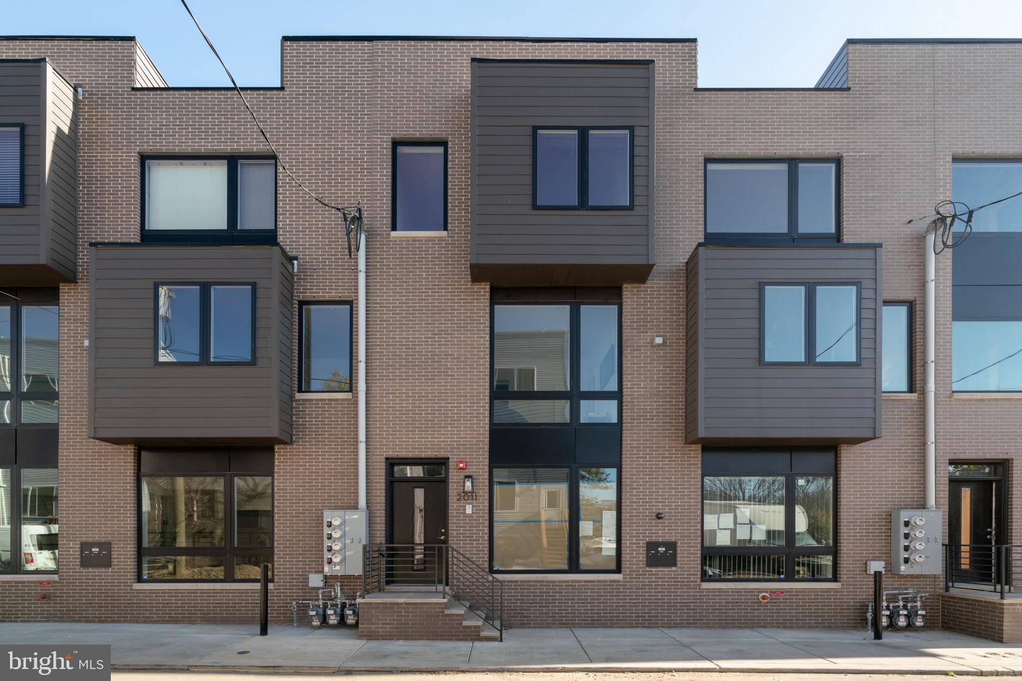 For anyone who loves new construction, this clean and contemporary condo offers the best lifestyle available at this price. Enjoy the natural wood floors, high ceilings, recessed lights, and smooth drywall finish that create a special feeling immediately upon entering. The kitchen features high quality finishes, including quartz countertops, 5-burner gas range, soft-close shaker-style cabinetry, new appliances, plumbed island, and bar seating. Thoughtful design touches such as wall-mounted electric and coax for clean installation of flat-screen TV, and electrical outlet in the kitchen island. Brand new LG washer/dryer, gas powered to dry faster while keeping utility costs low. Large picture-frame energy efficient windows overlook the common area courtyard below, which is attractively hardscaped and landscaped. Contemporary bathroom with quartz top vanity and ample drawer storage. Two large east-facing bedrooms enjoy fantastic morning light. Custom-built closet organizers with more shelving for shoes and racks for clothes than you'd ever expect, in both bedrooms! Of course, the HVAC is new and energy efficient, including central air conditioning. The property is blocks away from the Temple University train station with service to Center City and 30th St every 10 minutes. One block to the grocery store. Moments away from the best gathering spots like Human Robot, Philadelphia Brewing Co, The Ground Coffee, LMNO, Stateside Distillery, and Kalaya Thai Kitchen. There is no need to compromise on your condo, while still enjoying every benefit of a connected convenient location.