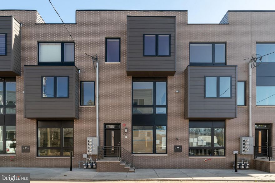For anyone who loves new construction, this clean and contemporary condo offers the best lifestyle available at this price. Enjoy the natural wood floors, high ceilings, recessed lights, and smooth drywall finish that create a special feeling immediately upon entering. The kitchen features high quality finishes, including quartz countertops, 5-burner gas range, soft-close shaker-style cabinetry, new appliances, plumbed island, and bar seating. Thoughtful design touches such as wall-mounted electric and coax for clean installation of flat-screen TV, and electrical outlet in the kitchen island. Brand new LG washer/dryer, gas powered to dry faster while keeping utility costs low. Large picture-frame energy efficient windows overlook the common area courtyard below, which is attractively hardscaped and landscaped. Contemporary bathroom with quartz top vanity and ample drawer storage. Two large east-facing bedrooms enjoy fantastic morning light. Custom-built closet organizers with more shelving for shoes and racks for clothes than you'd ever expect, in both bedrooms! Of course, the HVAC is new and energy efficient, including central air conditioning. The property is blocks away from the Temple University train station with service to Center City and 30th St every 10 minutes. One block to the grocery store. Moments away from the best gathering spots like Human Robot, Philadelphia Brewing Co, The Ground Coffee, LMNO, Stateside Distillery, and Kalaya Thai Kitchen. There is no need to compromise on your condo, while still enjoying every benefit of a connected convenient location.