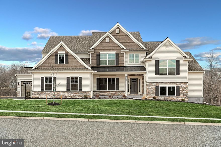 Designer details abound in this 2-story home featuring a 3-car garage with mudroom entry and laundry room access. A dramatic 2-story ceiling creates a grand first impression in the foyer, where elegant vinyl plank flooring extends throughout the main living areas. Just beyond the foyer and formal dining room with craftsman wainscoting, the 2-story great room is warmed by a gas fireplace with floor to ceiling stone. The kitchen is well appointed with enhanced appliances and cabinetry, quartz countertops with a tile backsplash, and a large island and pantry. Off the kitchen is a butler’s pantry, sunroom, and a breakfast area that provides access to the rear, composite deck. The home also boasts a spacious loft, a finished lower-level bonus room, and a private study with a cathedral ceiling. The first-floor owner’s suite accented by a tray ceiling includes a private bathroom with a tile shower, double bowl vanity, and an expansive closet. Three bedrooms with large closets and two full baths are located on the second floor.