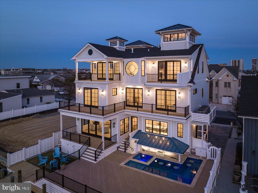 Owner financing is available.  Custom one of a kind 6BR/6BA/3HBA, new construction, direct west-facing bayfront estate is now complete. Designed and built by David Bradley of Bradley Construction, a respected architectural visionary known for his creative design and impeccable quality. Immerse yourself in the ambiance of this luxurious waterfront lifestyle while enjoying panoramic breathtaking views of the Assawoman Bay and skyline from the property’s L-shaped pool and swim-up bar. The property features exceptional craftsmanship with astute attention to detail, custom finishes, custom woodwork and architectural details. Upon opening the front doors, you are greeted with luxury and expansive views of the Assawoman Bay. To your right you will find a welcoming orange crush bar made with Port Rush quartz and the first-floor Den/bedroom ensuite complete with a Murphy bed. The expansive family room has a wall of windows and glass sliders overlooking the bay where you and your guests are sure to enjoy the cozy warmth of the gas fireplace in the fall and winter months. The gourmet chef's kitchen is just off the family room and includes plenty of bar seating with endless bay views, making it a dream entertaining space. The kitchen boasts GE monogram stainless steel appliances including a 6-burner gas range, expansive center island with seating for six, custom farm sink, with vegetable sink and hone marble and quartz countertops. The white custom Fabuwood cabinets are custom-made and come complete with undercounter lighting, appliance garages and custom pull outs for easy storage. Floating shelves in the kitchen are made with reclaimed wood, and the space is highlighted with a designer tile backsplash. There is also an expansive butler’s pantry with plenty of prep space and storage, a mud room with custom shelving designed in a nautical theme, a laundry room, and half bath on the main floor. To reach the second floor you can either take the white oak stairs or use the custom-made glass elevator which sports ocean views on the way up. On the second floor you will find 3 custom spacious ensuite Bayfront bedrooms, each with its own private balcony. There is also a fourth ensuite bedroom on this level which has been designed as a bunk room with custom bunk and trundle bed complete with a port hole . There is also a coffee bar and refrigerator, and full-size laundry on the 2nd floor. As you work your way up to the 3rd floor your breath will be taken away when you enter the doors of the primary bedroom ensuite with its bay views, cathedral ceilings, turret cupola, coffee bar, fireplace, exquisite tile work, and two enormous closets with wood detailing and shiplap. You will wake up refreshed with the calming sounds of the water each morning. There is an expansive covered porch off the primary bedroom. The primary bath has an insulated tub with jets and faces the bay with a 6ft-by-6ft circular Anderson window creating a sense of calm and relaxation. Also on this floor is a 2nd family room or party room with soaring ceilings and a cupola allowing an abundance of light to fill the room, perfect for entertaining or watching movies. There is a separate refrigerator and bar seating as well as a glass slider leading to a private deck overlooking the Bay. There is also a half bath and laundry on this level. As you venture on up the captains stairway in the front stair turret, you will find a panoramic 360 degrees view of OC and the ocean. You will never want to leave your new home with the saltwater pool and spa, cabana area complete with two outdoor TVs, two refrigerators, custom cabinetry and countertops with Caribbean backsplash. Off the deck you will also find a nice fire pit area. For the boating enthusiast this home has permits for three lifts and a transient boat can be accommodated. There is also a 50ft pier, dock and ramp. Parking for 6 cars. This home is a show-stopper!