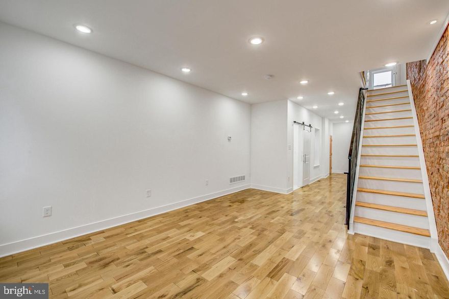 This stunning home is an investor’s dream. Currently occupied but will be delivered vacant,  everything is in place  just add appliances and an HVAC unit, and it’s ready to go. Step inside to find recessed lighting, brand new hardwood flooring, and abundant natural light streaming through newly installed windows. The generous first floor offers an open concept living room, dining area, and kitchen featuring new cabinetry, quartz countertops, and a classic subway tile backsplash. There’s also a brand new half bath tucked behind a stylish single barn door. An exposed brick accent wall adds character to the living room and continues up the staircase to the second floor, where you’ll find three spacious bedrooms and a beautifully updated bathroom with custom tiling and gold fixtures. Indulge in the luxury shower panel featuring a built-in rainfall shower head, high powered body spray jets, and a handheld shower wand. The primary suite boasts its own full bath, adorned with floor-to-ceiling black-and-white marble tiling and a matte black luxury shower panel. The fully finished basement offers endless possibilities use it as a second living area, home office, or entertainment space. Conveniently located near Center City Philadelphia, public transportation, and an array of restaurants and shops, this home is absolutely move-in ready with just a few final touches. Don’t miss out schedule your tour today and see the potential for yourself!