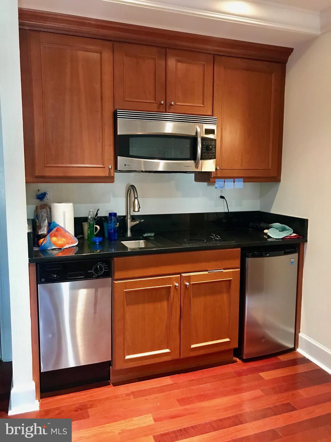 Studio residence with gorgeous city views on a high floor atop the Warwick Hotel! The home features an open layout with cherry hardwood floors throughout. The kitchen has wood cabinetry, granite countertops and GE stainless steel appliances. Adjacent to the living area, there is a full bathroom appointed in marble with a single vanity, spacious stand-up shower with a glass door and access to a washer/dryer with extra storage space. This studio would perfectly serve an individual who travels often or is looking for a part-time residence. Residents of The Warwick enjoy the same amenities as guests of The Warwick Hotel, which is on the thirteen bottom floors of the building. Amenities include a 24-hour doorman, state-of-the-art fitness room, and for an additional fee: maid service, room service, and valet parking.