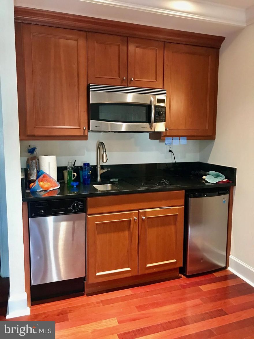 Studio residence with gorgeous city views on a high floor atop the Warwick Hotel! The home features an open layout with cherry hardwood floors throughout. The kitchen has wood cabinetry, granite countertops and GE stainless steel appliances. Adjacent to the living area, there is a full bathroom appointed in marble with a single vanity, spacious stand-up shower with a glass door and access to a washer/dryer with extra storage space. This studio would perfectly serve an individual who travels often or is looking for a part-time residence. Residents of The Warwick enjoy the same amenities as guests of The Warwick Hotel, which is on the thirteen bottom floors of the building. Amenities include a 24-hour doorman, state-of-the-art fitness room, and for an additional fee: maid service, room service, and valet parking.