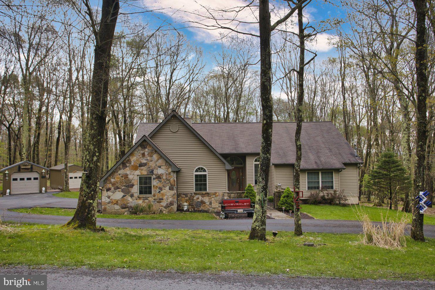 Tucked on a beautiful wooded 0.68 acre lot is this charming three-bedroom Craftsman-style home located in ALPINE LAKE RESORT! Home is being *SOLD TURN KEY* Inside, the home offers a warm, open layout with rich hardwood floors, classic Craftsmanship details throughout. The spacious Great room centers around a floor to ceiling stone fireplace, ideal for those cozy evenings, while large windows offer tons of natural light. Next to the Great room is a sitting area with a fully stocked bar area for entertaining. Beautifully updated kitchen combines modern functionality with classic elegance. Features granite countertops that stretch across generous prep areas, providing both durability and a touch of sophistication, the cabinetry offers ample storage, the beautiful lighting brightens the space, highlighting the granite's natural sparkle and enhancing the overall warmth of the room that opens to a breakfast area. Separate dining room that is perfect for those family meals and entertaining. The primary suite, located on the upper level, serves as a peaceful retreat with a walk-in closet and a spa-inspired bath complete with a jacuzzi tub and a separate walk-in shower. Main level also has a spacious bedroom with a gorgeous full bath next to it. Large 3rd Bedroom on the upper level for guests. Enjoy the outside areas that includes a covered gazebo & hot tub, huge back deck for entertaining and taking in the natural beauty all around you. Enjoy Alpine Lake's Amenities: 150-acre lake stocked with a variety of freshwater fish, sandy beach area, spacious boathouse that is used for meetings, recreation, dances, weddings, birthday parties etc. the Lodge has a dining area that seats 250 people, lounge and conference rooms. Spacious fitness center and game room. Indoor heated swimming pool. Miniature golf, Bocce courts, tennis/pickle-ball/basketball courts, 35-room hotel, 18-hole golf course, 35 acres of paved roads. Whether you are loooking for a Vacation Home or a Full Time Residence Alpine Lake has everything you are looking for! Call today to schedule a viewing of this Move-in property....