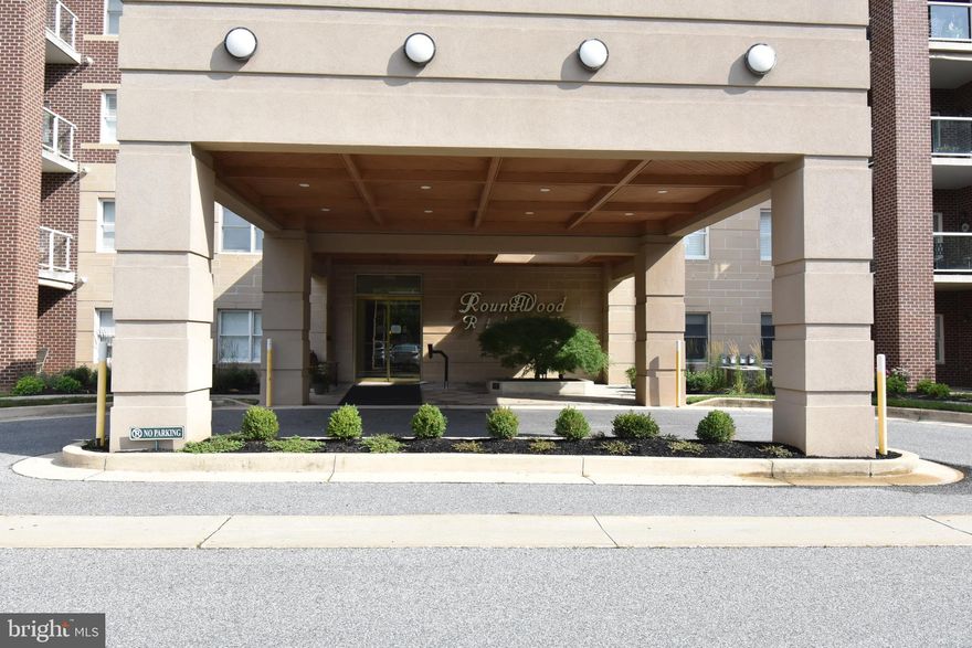 Welcome to one of the most popular and convenient living sites in Northern Baltimore County.  This near perfect condo is location on the 5th floor with breezy views of the Mays Chapel landscape.  Enjoy morning or evening strolls with a relaxing rest stop at the Gazebo before retiring back home.  In the colder months, enjoy cozy nights curled up in front of the gas fireplace which warms the unit beautifully.  

This home has been gently lived-in and is sparkling clean awaiting its’ new owner.   Enjoy the upgraded amenities of engineered Brazilian Cherry flooring,  a suite of Whirlpool Gold stainless steel appliances and KitchenAid dishwasher featuring ice and water available from the front door panel.  Honey Cherry wood kitchen cabinets with granite countertops grace the welcoming kitchen with tumbled stone ceramic tile flooring.  Enjoy additional base cabinetry and counter to serve as a bar area or server for entertaining together with a spacious pantry-style cabinet.  A convenient eat-at island is available for those quick breakfasts, lunches  or snacks.
The entire unit has been recently painted a neutral designer color.  The 50 gallon electric hot water heater was replaced in 2014 and the gas fired forced air furnace and central air conditioning have been well maintained on a regular schedule.  There is brand new high grade carpet in both bedrooms and crown molding in the Dining/Den and Living room along with recessed lights in the kitchen.   A new ceiling fixture was just installed in the Dining/Den.   Both bathrooms have new custom countertops and Moen faucets.

Additional amenities include a storage locker located just down the hall  across from the elevators  for your overflow storage needs.    When it’s time to entertain or host that special event, a recently redecorated activity room, complete with kitchen, located on the 3rd floor is provided to owners at no cost, just sign up.  The public first floor gathering room is a lovely area to greet your guests as they enter the building or just relax with neighbors.  This area is scheduled to be redesigned in the near future.  
 
Enjoy convenient items like a first floor mail drop off and pick up, plus each floor has a trash chute and plenty of parking both in the front and rear of the building.   Comcast and Verizon Fios are available to the building and this unit is Fios ready.  And the most important of all amenities – lovely, friendly neighbors to meet and enjoy at the building social get-togethers.

Note that we have procured the services of a virtual stager to give our prospects an idea for placement of furniture and use of rooms.  We have chosen to utilize the existing dining room as a Den with ancillary office space but of course it can be utilized based on your personal choice.