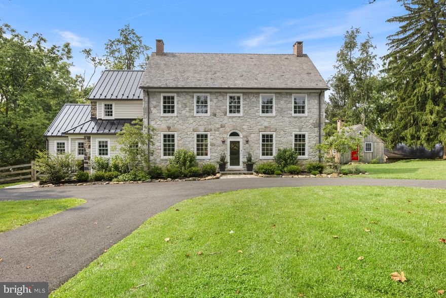 Springdale Farm is set in the heart of Pennsbury Twp in the rolling hills of the Brandywine Valley, known for its vista views and unparalleled scenic landscapes and for only the third time in more than 300 years, this 11+ acre farm is on the market. Originally part of the William Penn land grant, this land was home to the Mendenhall family for eight generations and is recognized as the oldest continuously run farm in Pennsylvania. It was painstakingly and meticulously brought back to life in 2019 with a top-to-bottom renovation while paying great homage to its history by having many of its original details restored in the process. It’s a truly unique property: a meticulously restored and updated Federal-style farmhouse and guest cottage in an idyllic country setting. A long driveway wends through verdant pastures to the home’s elegant façade, constructed of limestone in 1836 and crowned with a cedar shake roof installed during the renovation. A complimentary standing seam metal roof, also new, is atop the earliest section of the house, built in 1720. The sides and back of the house were crafted from local fieldstone. Gutters and downspouts are copper. In keeping with modern life, an expansive deck has been added to the back of the house. The deck is accessed by an addition that encompasses a gourmet kitchen that is open to a family room with a vaulted beamed ceiling and panorama views of the countryside. The kitchen is a chef’s dream—with a Wolf range, sub-Zero refrigerator, large, farmhouse-style sink and spacious pantry cupboard. A fifteen-foot island with quartz countertop seats six comfortably. White oak floors are set in a herringbone pattern. The massive granite threshold is worn by footsteps of past generations. A butler’s pantry with dry bar services the kitchen and formal dining room, which has a large stone fireplace. The powder room features a vessel sink and vintage-style brass tap. There are two red brick fireplaces in the large living room. Throughout the first floor are extraordinary architectural elements, including stately crown moldings, original raised-panel window returns, a turned back staircase, classic front door and hardware, and original chestnut wood floors. The second and third floors are devoted to four generously sized bedrooms, each with a large closet and ensuite bath with high-end finishes. The second-floor primary suite boasts a room-size closet and a sumptuous bath with soaking tub, rain shower, heated floor and dual vanity. A coveted second-floor laundry room offers additional storage, a counter for folding laundry and a rod to hang clothes. Dormers added during the renovation on the third floor usher in natural light. In bringing back the house, the idea was to preserve the past—only better. The home was already graced with nine-foot ceilings; recessed lighting was installed during the renovation. A four-zone, state-of-the art electric and propane HVAC system ensures comfort while conserving energy. Andersen Architect Series windows combine an 18th century esthetic with 21st century energy efficiency. There’s a new septic system and artisanal well equipped with a high-tech water purification system. A basement with dirt floor was dug out and a concrete floor was laid to create a space with the ceiling height to accommodate a gym, home theater, workshop or other space. The grounds are a nature lover’s paradise, shaded by three towering sycamores more than 200 years old. The old summer kitchen has been reinterpreted as a gardening shed and studio equipped with a wood-burning fireplace. Two other outbuildings act as storage for a tractor and other outdoor equipment. Springdale was named for the three natural springs that still wind through the property. The original spring house is now a delightful one-bedroom guest cottage which was restored along with the main house and is complete with a kitchenette, living space, large bedroom and bathroom.