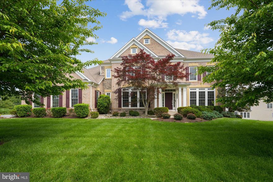 CROWN JEWEL OF OLNEY | AN EXCLUSIVE PULTE LUXURY HOME ON NEARLY ONE ACRE OF WOODED LOT

Welcome to  the largest model in The Reserve at Fair Hill—a stunning 5 BR, 5.5 BA stone-and-brick front Colonial offering 7,776 sq ft of refined living space on a private 0.8+ acre wooded lot. Built in 2009 by nationally renowned Pulte Homes, this residence is one of only two of its kind in the neighborhood. With over $100K in luxury exterior upgrades—including a handsome portico, expansive flagstone patio, full-yard irrigation with sub-meter, and an in-ground sprinkler system—this custom home is a rare find!

Step into a grand TWO-STORY FOYER  with dual staircases, wrought iron railings, and gleaming hardwood floors. Formal LIVING and DINING ROOMS boast nearly floor-to-ceiling windows, crown molding, chair rail, and wainscoting.    At the heart of the home is a gourmet KITCHEN and BREAKFAST ROOM, outfitted with rich cherry cabinetry, granite countertops, a large center island, and premium GE Profile stainless steel appliances, including a double wall oven, five-burner gas cooktop, and French door refrigerator. A built-in desk with upper cubbies, a spacious pantry, and recessed lighting complete the space.

Flowing seamlessly from the Kitchen is a bright SUNROOM with vaulted ceilings and Palladian windows floods the space with natural light.  A coffered-ceiling FAMILY ROOM with a gas fireplace offers a cozy retreat.  Additionally, a private HOME OFFICE with French doors, a POWDER ROOM, a large LAUNDRY ROOM, and a ceramic-tiled MUDROOM with granite-topped storage and a SECOND STAIRCASE to the upper floor complete the main level. The oversized three-car garage includes windows and ample storage.

UPSTAIRS, French doors open to a luxurious  PRIMARY SUITE with a crown-molded tray ceiling, sitting area, and ceiling fan. The spa-like bath features a sunlit Jacuzzi tub, walk-in shower, private water closet, linen closet, and dual vanities, including one with a built-in makeup station. A sprawling walk-in closet, configured as three separate rooms, adds an exceptional touch of luxury and organization. Three additional  bedrooms each include ensuite baths, ceiling fans, and generous closet space. Rich hardwood floors span the entire level, and a double-door linen closet offers added storage convenience.

THE WALK-OUT LOWER LEVEL is a spacious and sunlit retreat, recently updated with new carpet (2025). A large rec room with built-ins opens to the backyard patio through sliding glass doors. A full bath with granite vanity and tub/shower combo is shared with the fifth bedroom, while a second office can be converted to a legal sixth bedroom. A large utility/storage room provides space for a second refrigerator, seasonal items, and more.

STEP OUTSIDE to a beautifully designed flagstone patio, partially covered by a waterproof deck and enhanced by a portico with a ceiling fan—ideal for year-round al fresco living. Elegant brick stairs lead to the driveway, while curated landscaping with mature trees ensures privacy and beauty throughout all seasons.

ADDITIONAL HIGHLIGHTS include a three-zone HVAC system: gas heating and central air on the main and upper levels, and an energy-efficient heat pump on the lower level.

THIS EXCEPTIONAL HOME blends timeless design, thoughtful upgrades, and a premium setting in one of Olney’s most sought-after communities. Don’t miss your opportunity to own this one-of-a-kind ge