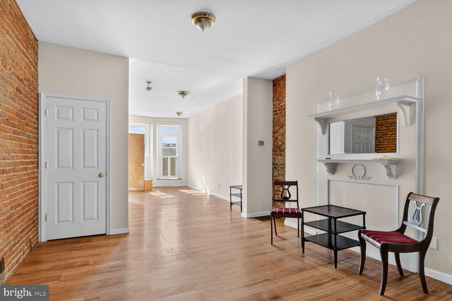 So many opportunities with this versatile property in the midst of Federal Hill, steps to everything. The 1880 row house is a fee-simple property; no ground rent. It consists of two units, one per floor, metered separately. Unit 1 on the lower level is zoned commercial and can be used as an office, a shop, or a gallery - whatever your vision is! The space features beautiful hardwood floors throughout, a light-filled sitting area with bay windows, a versatile area with an ornamental fireplace mantel, and a long, exposed brick wall. The back room, which is a permitted addition, can be used as storage or an additional office space. There is a half bath and access to a large unfinished basement, which houses a utility room and offers plenty of space for extra storage. The upper Unit 2 has a good-sized bedroom, a sitting area with an ornamental mantel and exposed brick wall, a full bathroom with a washer/dryer, and a kitchen with space for a table. The kitchen has a sliding door access to a large deck over the addition (decking was removed to fix the roof membrane). Sold as-is. The roof is fixed, and you can finish the design to match your vision!