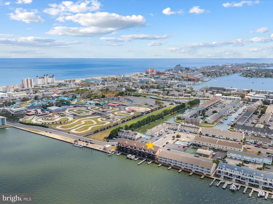 Experience the charm of bayfront living in this pristine first-floor condo offering 2 bedrooms and 2 full bathrooms. From the comfort of your home, take in some of Ocean City’s most spectacular open bay views with vibrant, ever-changing sunsets. A spacious deck provides the perfect setting to relax or entertain while enjoying the serene waters. This fully furnished residence is part of a well-cared-for community that includes an outdoor pool, a 50’ shared pier, and convenient gated on-site boat storage.

Inside, the inviting kitchen is appointed with stainless steel appliances, a stylish backsplash, room for a table, a breakfast bar, and a storage pantry. The primary suite is a true retreat, featuring an ensuite bathroom and its own private balcony. Thoughtful updates include a new HVAC system (2024), water heater (2023), primary bedroom sliding door (2023), high-capacity washer and dryer (2020), and garbage disposal. With no rental history, this home is move-in ready—perfect for embracing a relaxed coastal lifestyle and creating lasting memories at the beach.

Beyond the property, you’ll love the location. Just minutes away, enjoy the iconic Ocean City Boardwalk with its shops, arcades, and eateries, or spend a fun-filled day at Jolly Roger Amusement Parks. Midtown’s lively dining and nightlife—including the renowned Seacrets—is right nearby, while history buffs can explore the Ocean City Life-Saving Station Museum at the inlet. For a memorable outing, Assateague Island National Seashore and its famous wild horses are only a short drive away.