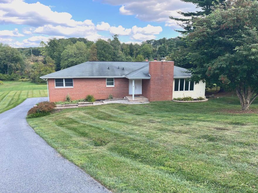 This charming raised ranch offers a perfect blend of comfort and style, nestled in a serene setting. Step inside to discover a spacious open floor plan. The inviting kitchen features stainless steel appliances, a cozy breakfast area, and ample pantry space, ideal for culinary enthusiasts.   Relax in the living room by the warmth of one of two brick fireplaces, creating a welcoming atmosphere for gatherings. The home boasts three well-appointed bedrooms on the main level, including a primary suite with ample closets and private bath with walkin shower. Enjoy the convenience of main-floor laundry and a fully finished basement with walkout access, perfect for entertaining.  There are 2 additional bedrooms in the basement each having both nice size closets and windows.  Enjoy large backyard from expansive deck.  Patio below the deck provides additional covered outside space.  Nicely laid out with some updates.  You will enjoy this kitchen as you can stand at the stove and view the dining and living room fireplace while cooking! Lower level has space for additional bath. 2 car garage and plenty of parking.