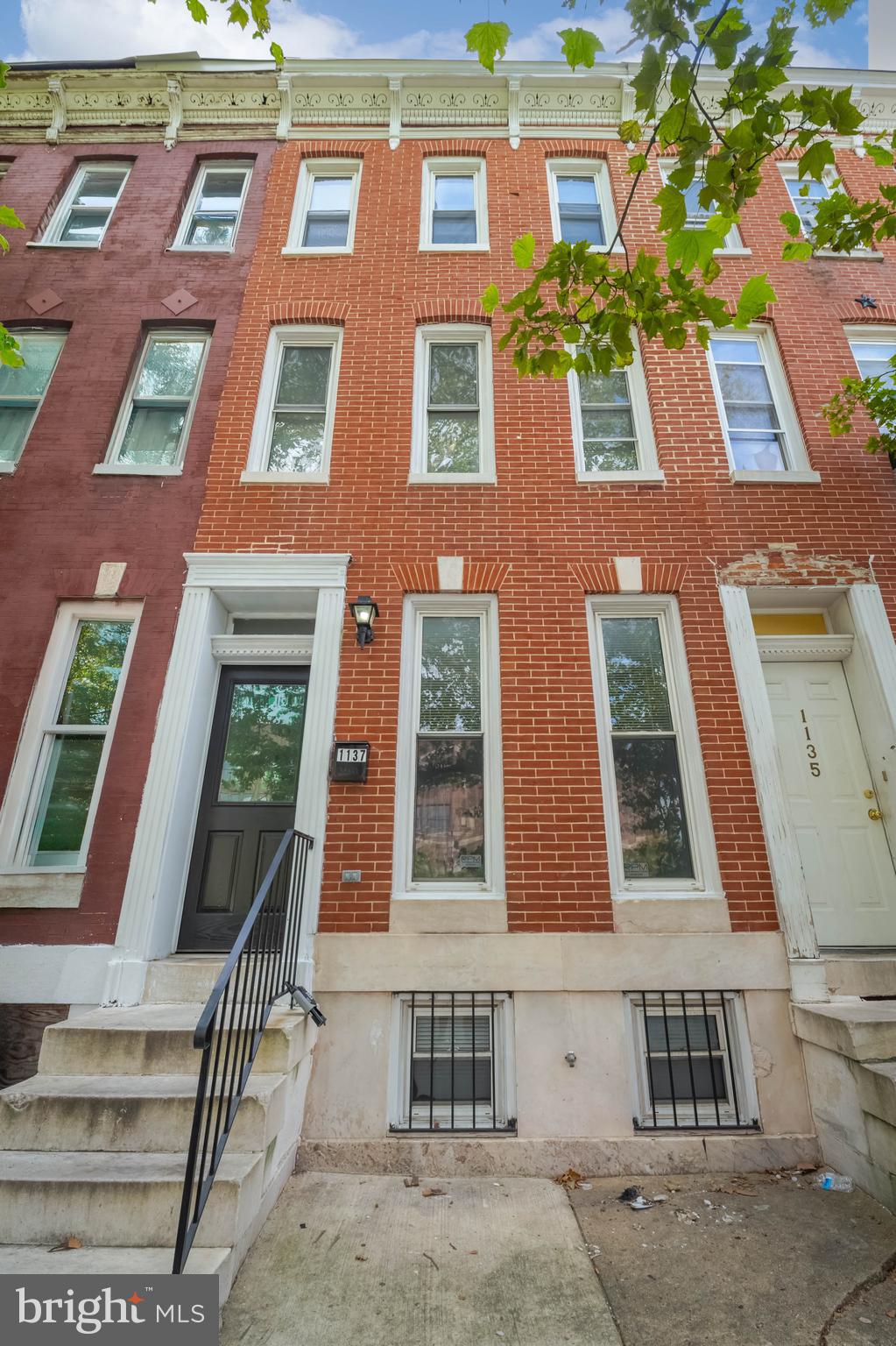Welcome to 1137 N. Mount Street, a spacious three-story rowhome located on a charming tree-lined street in the historic Sandtown-Winchester neighborhood. This move-in ready home has been freshly painted and features brand-new carpet, a new stove, and a new washer and dryer—everything you need to settle in comfortably. The main level offers a traditional floor plan with a generous living room, formal dining room, and a kitchen with ample cabinet and counter space—perfect for both daily living and entertaining. On the second floor, you’ll find two large bedrooms and a full bath with a tub/shower combination. The third floor boasts a spacious third bedroom, a versatile loft area ideal for a home office or media room, and a second full bath—creating the perfect setup for a private primary suite retreat.
The unfinished basement offers abundant storage space and potential for future customization. Additional highlights include central air conditioning and a MDE Lead Cert. The rear-fenced yard is perfect for outdoor entertaining. Enjoy close proximity to major commuter route of I-95, Gwynns Falls and Carroll Park (with its own golf course), Saint Vincent de Paul’s Sarah’s Hope, University of Maryland at Baltimore, Coppin State University, and the West Baltimore MARC Station. Plus, you're just minutes from M&T Bank Stadium, Oriole Park at Camden Yards, Downtown Baltimore, Little Italy, and more. Don’t miss this opportunity to own a well-appointed home in a convenient and growing neighborhood. Welcome home!