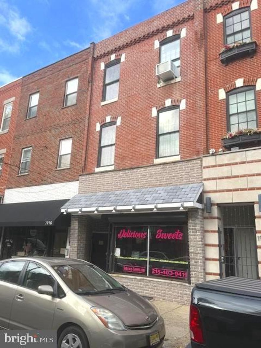 Mixed-use property on prime Passyunk Avenue (Restaurant Row), featuring a Commercial space and a large bi-level 2-Bedroom Apartment.  The Commercial space offers high ceilings, a security system, a bright front area with a glass entry door and large display windows protected by exterior roll up Security Gates, a Prep area (currently used as a Kitchen), and a rear section with a mop sink and Half Bath.  The Basement can be accessed from inside the Commercial area or through exterior Bilco doors.  The previous 1st Flr tenant was Delicious Sweets.  All utilities (electric, gas, and water) are separately metered.  The Apartment, spanning the 2nd and 3rd floors, includes a large Primary Bedroom, a Kitchen with Washer and Dryer, Full Bathroom, and Living Room on the 2nd floor.  The 3rd floor is one large Bedroom space currently with multiple beds.  It is believed, though not confirmed, that plumbing exists on the 3rd floor, possibly offering potential to create 2 Bedrooms and an additional Full Bathroom.  Located just one block from Broad Street, this property sits in a high-traffic, trendy, and walkable area with excellent visibility and foot traffic.
