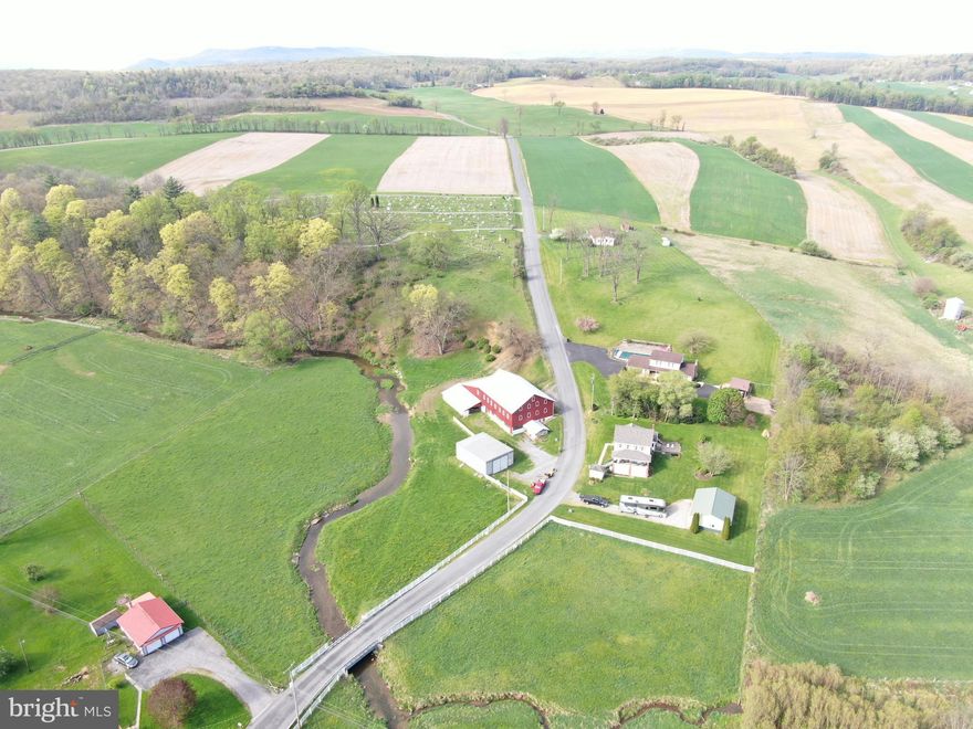 PICTURESQUE 46.11± ACRE FARMETTE IN HUNTINGDON COUNTY, PA! 
Tract 1: 6.30± Acres Features a 2-story farmhouse, large bank barn, 30x40 shop, 24x36 newer detached garage, and Warriors Mark Run flows through the property! The farmhouse includes 3 bedrooms, 1.5 bathrooms, living room, dining room, family room, sunroom, foyer, covered porch, attic, and basement. Located in a beautiful area and also convenient to local towns and roadways. Approx. 20 miles to State College and Huntingdon, and 26 miles to Snyders Run boat launch at Raystown Lake, 7 miles to Tyrone. 
Tracts 2 & 3: Tract 2 is 18.94± Acres and Tract 3 is 20.87± Acres. These two lots have two perc approved sites and would make for a beautiful homesite! Incredible views and convenient to local towns and roadways. Approx. 20 miles to State College and Huntingdon, and 26 miles to Snyders Run boat launch at Raystown Lake, 7 miles to Tyrone. Property is all tillable and soils are primarily Hagerstown silt loam, fields lay flat, and are nice and open. Building and permit questions should be directed to Warriors Mark Township.  

This property will be offered as a multi-parcel auction meaning multiple tracts will be available for sale. The property will be offered in individual tracts, combinations of tracts, and as a whole. 

Tract 1: 6.30± Acres with a farmhouse, barn, shop, detached garage, Warriors Mark flows through.
Tract 2: 18.94± Acres w/ frontage on Burket Rd, Perc approved
Tract 3: 20.87± Acres w/ frontage on Burket Rd, Perc approved
Tract 4: 2± Acres w/ frontage on Burket Rd, Perc approved

Taxes will be reassessed if the tracts sell as individual tracts or as combinations. 

This property will be offered at auction on Friday, July 11, 2025 @ 3:00pm. The List price in no way represents a minimum, starting, or acceptable bid.