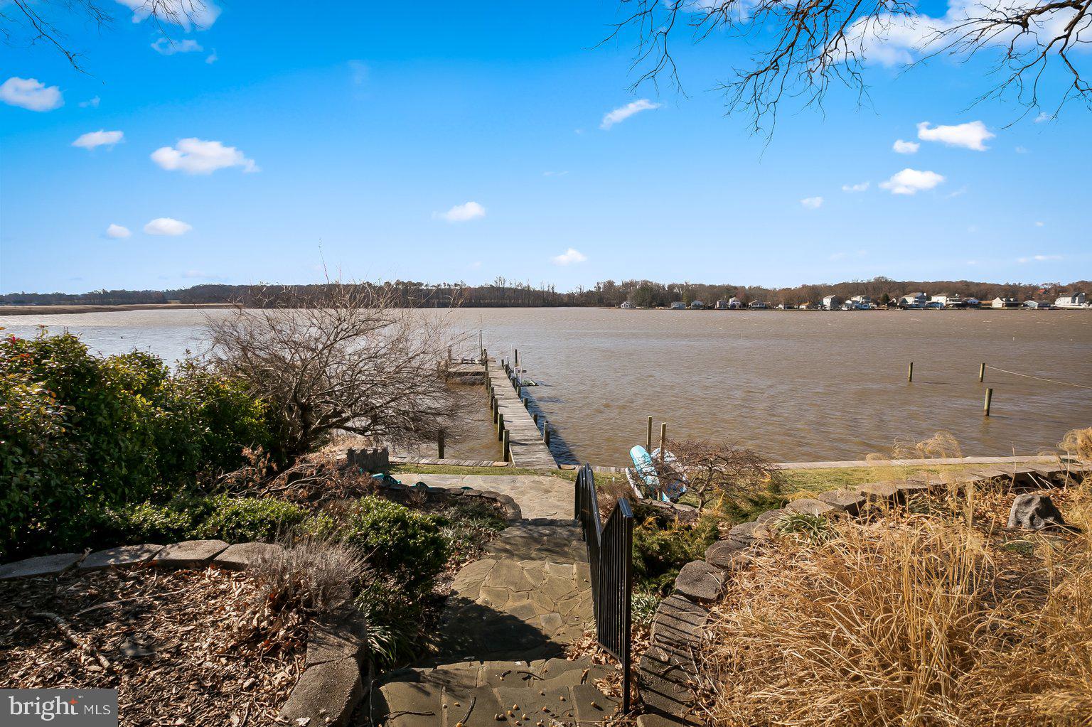 Come live your waterfront dreams at this Loreley Beach home! Anchored by a stunning south view of the Bird River, this 4 BR, 2 BA house has full access to the water with a pier, a boat lift, two jet ski lifts, gorgeous hardscaping, a fully-fenced back yard and a detached, two car garage. Want ample hangout spaces outside? You've got it on the covered front porch, open back deck and timeless stone patio, all fabulous spots for you and your guests to make the best memories. Inside are generously-sized rooms with an updated kitchen and all of the requisite stainless steel appliances. Check out the main floor bedroom with the wide barn door that leads to the family room, ideal for easy accessibility and both with a water-view! Both bathrooms have been fully updated, with the primary bathroom having an exceptionally ample clawfoot tub, just perfect for soaking away your stress, along with a gorgeous shower. Very recent updates include a new heat pump and AC in 2022. Community amenities include a clubhouse, a pier and a boat ramp, all without the restrictions of an HOA. Flood insurance not required for this property. This beautiful waterfront home is a must see!