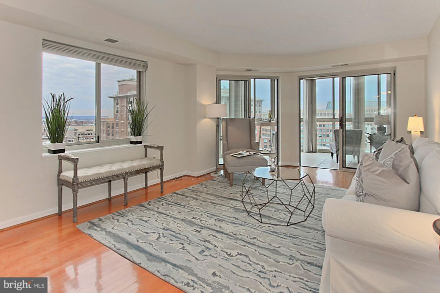 Light & bright open, unique floorplan w/many updates. Wood floors throughout the main living space. Stunning kitchen renovation including sub Zero, panel fridge, new cabinets, and more. Sunny encl balcony, not incl in 1,145 sqft. Large MBR w/2 closets. MBA has dual vanity, glass encl shwr & sep tub. Sought after South bldg w/quiet view away from the trains. Walk to 2 metros, Whole Foods, shops, restaurants, movies etc. Enjoy pool, tennis, 2 gyms, putting green & 24-hr security. 1 garage & storage included in price.