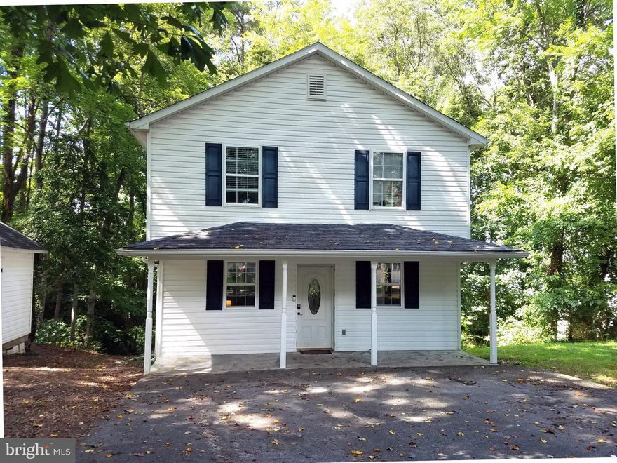 Coastal Cottage-style Colonial with water view set amongst the trees. Walk in and say "wow" to the gorgeous 2020-installed laminate wood flooring throughout! This 3 bedroom, 2.5 bath home offers open concept living on the main floor. Kitchen with island, maple cabinets, stainless appliances, open dining area and living room with brick hearth and pellet stove. Enjoy the privacy of the woods out back and look out onto Indian Creek as it opens onto the Patuxent River. As the leaves drop in Autumn, the view continues to improve! Upstairs features three nice-sized bedrooms. Primary bedroom includes double ceiling fans and large walk-in closet. Enjoy the breeze on the covered front porch or sit around the fire ring in the evening. Good size shed and lower level unfinished room provide extra storage and great workshop space. Rear main-level door has potential to lead to the deck of your dreams! Home is NEST-controlled and smart-wired. Park your boat or camper - voluntary HOA is for use of Golden Beach boat ramp, picnic pavilion and dock. Convenient to PAX, D.C., Prince Frederick and shopping. Don't miss this one, set up your showing today!
