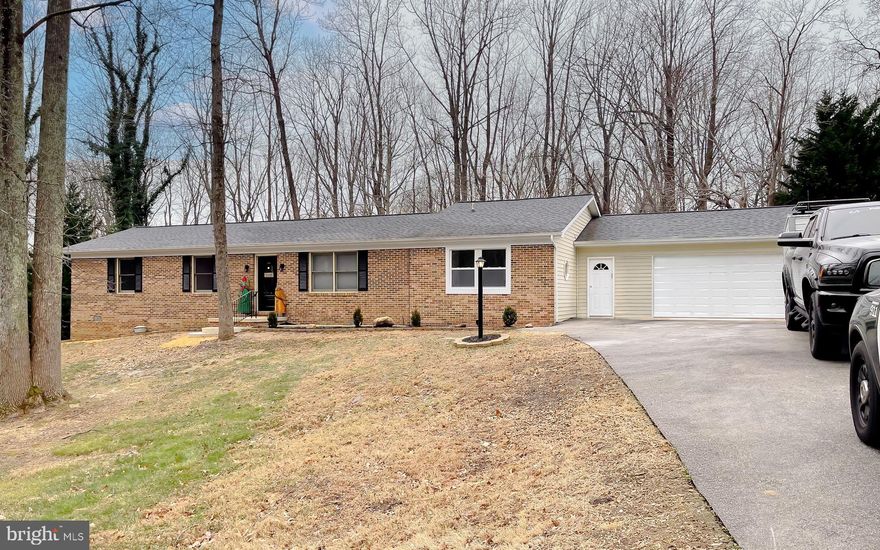 Welcome to this updated 3 Bed, 2 Bath, brick front single story home located in Northern Saint Mary's County. This home features a comfortable, functional layout as you enter through the front door. Step inside to an inviting, yet versatile space that can serve as a dining or sitting room. To the left features two spacious bedrooms, full bath with modern finishes and main level laundry room. The newly renovated kitchen features bright white shaker style ceiling height cabinetry with oversized pantry. Completing the kitchen finishes are high quality Caesarstone White Attica quartz countertops, full height easy to clean matching quartz backsplash, and all new stainless steel appliances. The kitchen flows into a beautiful bright living/great room with fireplace and abundant natural light from the skylights above. To the front of the house enjoy the master bedroom which features a large closet and is accompanied by a generously sized en-suite bathroom. Key features are the slip resistant tiled shower, textured tile flooring, Caesarstone quartz topped double vanity and stand alone soaking tub that is sure to impress. New, easy to maintain waterproof/pet proof Pergo flooring flows throughout the home. A two car attached garage with a newly installed, smooth operating 16X7 door protects your vehicles from Mother Nature. The unfinished basement has exterior access and is a blank slate to cover all of your storage or home gym needs. Outside the home continues to impress with new landscaping that adds natural beauty. The rear of the house features a oversized, newly stained, partially covered  deck which adorns this home and is great for entertaining or relaxing. Roof replaced 2018, HVAC 2019. With its thoughtfully improved interior and impressive outdoor space, 29765 Dogwood Circle is a standout property that offers ample space, function and endless possibilities.