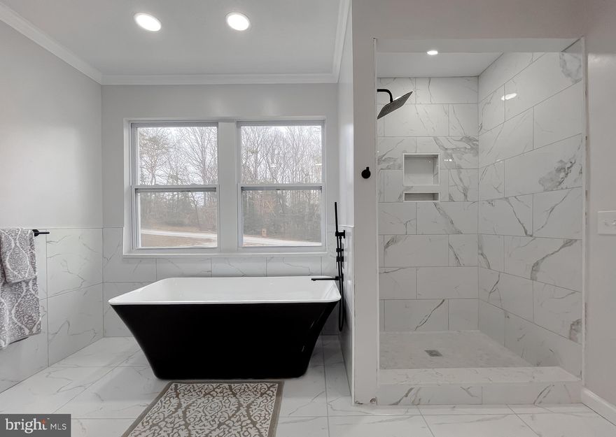 Welcome to this updated 3 Bed, 2 Bath, brick front single story living style home located in Northern Saint Mary's County. This home features a comfortable, functional layout as you enter through the front door. Step inside to an inviting, yet versatile space that can serve as a dining or sitting room. To the left features two spacious bedrooms, full bath with modern finishes and main level laundry room. The newly renovated kitchen features bright white shaker style ceiling height cabinetry with oversized pantry. Completing the kitchen finishes are high quality Caesarstone White Attica quartz countertops, full height easy to clean matching quartz backsplash, and all new stainless steel appliances. The kitchen flows into a beautiful bright living/great room with fireplace and abundant natural light from the skylights above. To the front of the house enjoy the master bedroom which features a large closet and is accompanied by a generously sized en-suite bathroom. Key features are the slip resistant tiled shower with glass doors, textured tile flooring, Caesarstone quartz topped double vanity and stand alone soaking tub that is sure to impress. New, easy to maintain waterproof/pet proof Pergo flooring flows throughout the home. A two car attached garage with a newly installed, smooth operating 16X7 door protects your vehicles from Mother Nature. The unfinished basement has exterior access and is a blank slate to cover all of your storage or home gym needs. Outside the home continues to impress with new landscaping that adds natural beauty. The rear of the house features a oversized, newly stained, partially covered  deck which adorns this home and is great for entertaining or relaxing. With its thoughtfully improved interior and impressive outdoor space, 29765 Dogwood Circle is a standout property that offers ample space, function and endless possibilities.mm