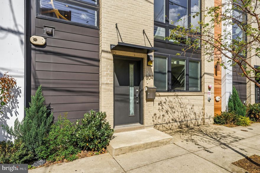 Welcome to 604 N 4th Street, a sophisticated four-story townhome tucked within a private gated community in the heart of Northern Liberties, where thoughtful design, intelligent technology, and effortless entertaining converge. A rare two-car attached garage anchors the entry level, joined by a gracious foyer, powder room, and coat closet.

The finished lower level delivers genuine flexibility: wall mirrors and a dedicated wellness space currently configured as a boutique home gym, with room to adapt as your needs evolve.

The main living level is built for both quiet evenings and full-house entertaining. A stone gas fireplace anchors the room, flanked by oversized Andersen windows with remote-controlled blinds. The kitchen doesn't compromise: Viking six-burner range with pot filler, Miele wall oven and steam oven, Bosch dishwasher, built-in wine refrigerator, quartz countertops, and a hammered metal farmhouse sink. A dining area flows into a built-in dry bar with dedicated storage, a layout that feels permanent and purposeful.

The second floor offers two generously scaled bedrooms, each with a private en suite bath, plus a full laundry room with additional storage conveniently on this level.

The entire third floor belongs to the primary suite. The custom walk-in closet is outfitted floor to ceiling. The spa bath features heated floors, a towel warmer, mirror defogger, double vanity, soaking tub, and glass-enclosed shower. A private wet bar with beverage fridge, sink, and cabinetry doubles as a morning coffee station and evening retreat, with access to a private balcony beyond.

Above it all, the roof deck delivers what Northern Liberties promises: panoramic 360° views of the Philadelphia skyline, a dedicated gas line for grilling, built-in outdoor speakers, and wired for television and internet, a fully finished outdoor room that sets this home apart from nearly everything in its class.

Throughout: Savant whole-home automation integrating lighting, AV, climate, garage, and security. Sonos multi-zone audio through built-in speakers throughout every level of the home and roof deck. Lutron smart switches and thermostats. Haiku ceiling fans in every bedroom, the wet bar, and living room. 5.1 surround sound in the living room. Level smart lock. Whole-home water filtration with reverse osmosis at the kitchen sink. Andersen windows throughout. Hardwood floors on every level.

Step outside and you're in the middle of Northern Liberties at its best. Café La Maude, North Third, Yards, and Bourbon & Branch within blocks, with seamless access to I-95, 676, and public transit.