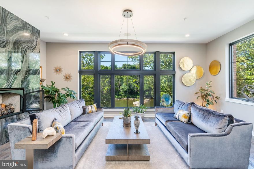 Welcome to 4554 Riverside Way at The Locks Townhomes in Manayunk! This modern gem stands out as an exceptional offering, with an extra-wide floor plan (23 feet wide) and a coveted corner position that floods the space with breathtaking natural light and stunning river views. Plus, you'll be delighted to discover a fantastic 10-YEAR TAX ABATEMENT, still with 7.3 years remaining! With 4 bedrooms and 3.5 bathrooms, a 2-car garage, 5-stop elevator, and an amazing roof deck, this home is thoughtfully designed to cater to your every need, seamlessly blending comfort and elegance.

As you enter, the inviting and stylish living room welcomes you with picturesque windows and captivating river views. Ample closets, the first elevator stop, and a two-car garage with custom workshop shelving and sleek epoxy floors add sophistication and practicality.

Venture up to the second level, where an awe-inspiring open floor plan awaits, perfect for creating cherished memories with loved ones. Beautiful hand-scraped hickory hardwood floors extend throughout, complemented by recessed lighting and a built-in speaker system. The family room features a gas fireplace with a floor-to-ceiling marble surround, exuding warmth and grandeur. Floor-to-ceiling windows frame stunning river views and create a seamless connection with the outdoors. The adjacent open dining area leads to a thoughtfully designed powder room for your guests, and another entrance to the elevator.

For culinary enthusiasts, the upgraded, high-end chef's kitchen is a dream come true, featuring soft-close cabinetry, a gorgeous backsplash, and a custom pantry by California Closets. Stylish pendant lighting graces the 4-person breakfast bar/island, while top-of-the-line Wolf, Asko, and Subzero appliances elevate your cooking experience. Just off the kitchen you will find a flexible space which can be used as an eat in kitchen area or secondary den complete with a bar w/ beverage refrigerator and additional cabinetry and counter space. The built-in Speaker system sets the mood for every occasion, while Hunter Douglas Silhouette shades adorn all levels, adding privacy and beauty in equal measure.

On the third level, you'll find three generously sized bedrooms, one being an en-suite guest bedroom with mechanical shades and a modern bathroom with a stall shower, as well as a laundry room and a full hallway bathroom.

The primary suite is a true sanctuary, encompassing the entire fourth floor. It boasts an array of amazing details and features, including a perfectly placed and sleek wet bar area, a private balcony, a stunning walk-in closet, custom bookshelves, and additional closets thoughtfully designed and outfitted by California Closets. Motorized shades add convenience, while an additional room offers versatility as a sitting room, nursery, or office. The spa-like bath is a luxurious retreat with a double vanity, quartz counters, a large frameless glass shower with a bench seat and rain shower head, as well as a soaking tub.

Take a brief stroll over the canal, and you'll find yourself in the heart of Manayunk, where unique restaurants, bars, galleries, and boutiques await! Embrace the distinct and charming downtown atmosphere of Manayunk, with nature trails for running and riverbank paths for leisurely walks. The Locks also provides easy access to Center City, Philadelphia, via the Manayunk SEPTA station or a quick drive.

Don't miss the chance to seize the ultimate in upscale living at The Locks Townhomes in Manayunk!