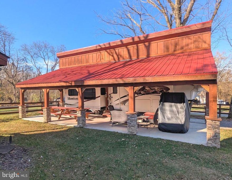 Come see this stunning turn-key property, complete with a Montana fifth wheel camper and a cozy guest house. Enjoy a nice concrete pad under the pavilion, all situated on a fully fenced corner lot.

Welcome to River Bend! This turn-key seasonal lot is part of a privately owned 400-acre RV camp resort offering plenty of seasonal activities for members, families, and guests. Tucked away on the Upper Potomac River in West Virginia, River Bend is one of the state’s favorite family destinations, just a short drive from the Washington, D.C., and Baltimore metro areas. Open with utilities from April 1 to November 1, lot owners enjoy year-round access to their property. Members can take in stunning views and wildlife, enjoy river access, trails, swimming pools, mini-golf, a youth center, tennis and basketball courts, laundry facilities, a convenience store, deli, and lounge. The park also features bathhouses, a boat ramp, a bar and grill, and even a church on-site. Seasonal events include 4th of July fireworks, a small carnival, bonfires, poker runs, horseshoe tournaments, a car show, Halloween trick-or-treating, and much more.