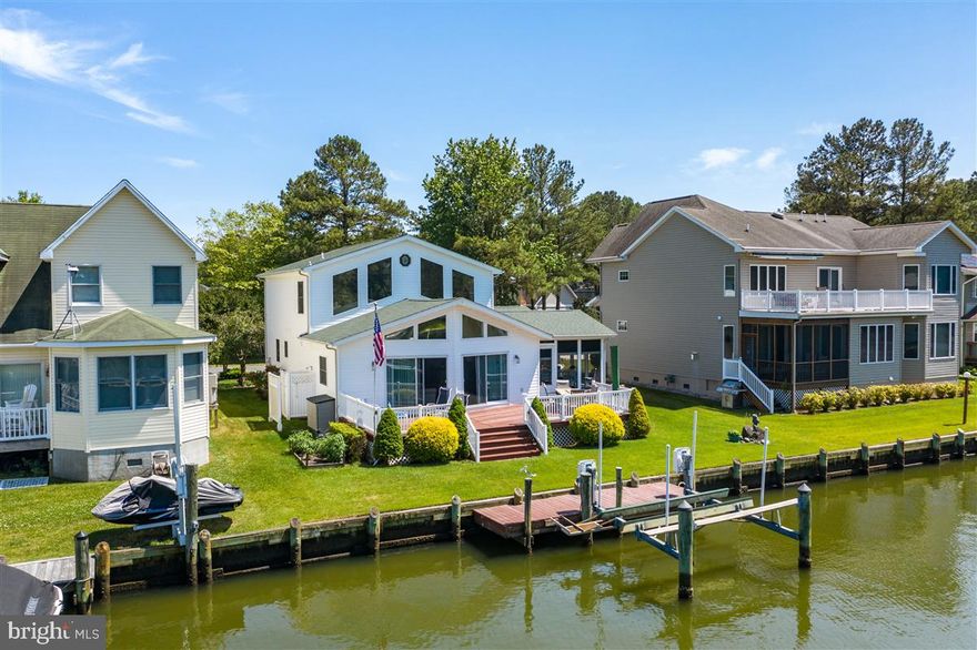 This nicely maintained 5 bedroom, 3 bath waterfront home (plus den, loft and 3 season room) is a must see.  Fabulous Teal Bay location with easy access to open water and dock with lift.  Lovely views of wide canal basin.  Great home for entertaining with open living areas and large deck with awesome water views.  Kitchen offers stainless steel appliances, beverage fridge, 42 in hickory cabinets and ceramic tile flooring.  Wall mounted smart TV and nice built in the living room will convey.  One car garage houses built in cabinetry for convenient storage.   Additionally this home has a paved driveway and outside shower.   Roof is only 2 years old (2018).