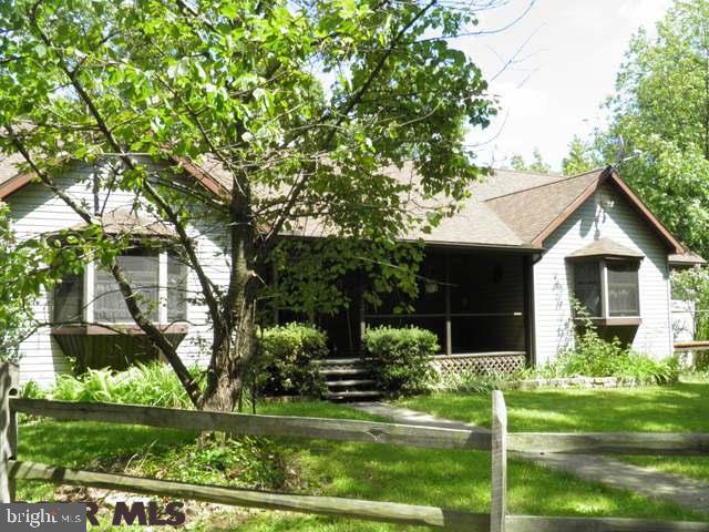 Secluded Ranch Home with log look interior on 12+ acres. Located 15 minutes from Lock Haven University and 30 Minutes to Penn State. Interior has open floor plan with two story fireplace in center of house, stunning hardwood floors, over sized hallways for handicap accessibility, two loft rooms connected by walk way open to lower level and roughed in plumbing for 3rd bath, new high-end master bath with jetted tub, tile shower and over sized windows looking out to woods, new furnace, new roof, and new water filtration system. Basement is ready for new owner to finish to their taste with sliding glass doors to exterior. Exterior has one deck with screened outdoor living space and second deck off of formal dining room for additional entertaining space, rustic fence, large yard and woods with large oaks ready to be timbered. Year round living or great second home get-a-way!