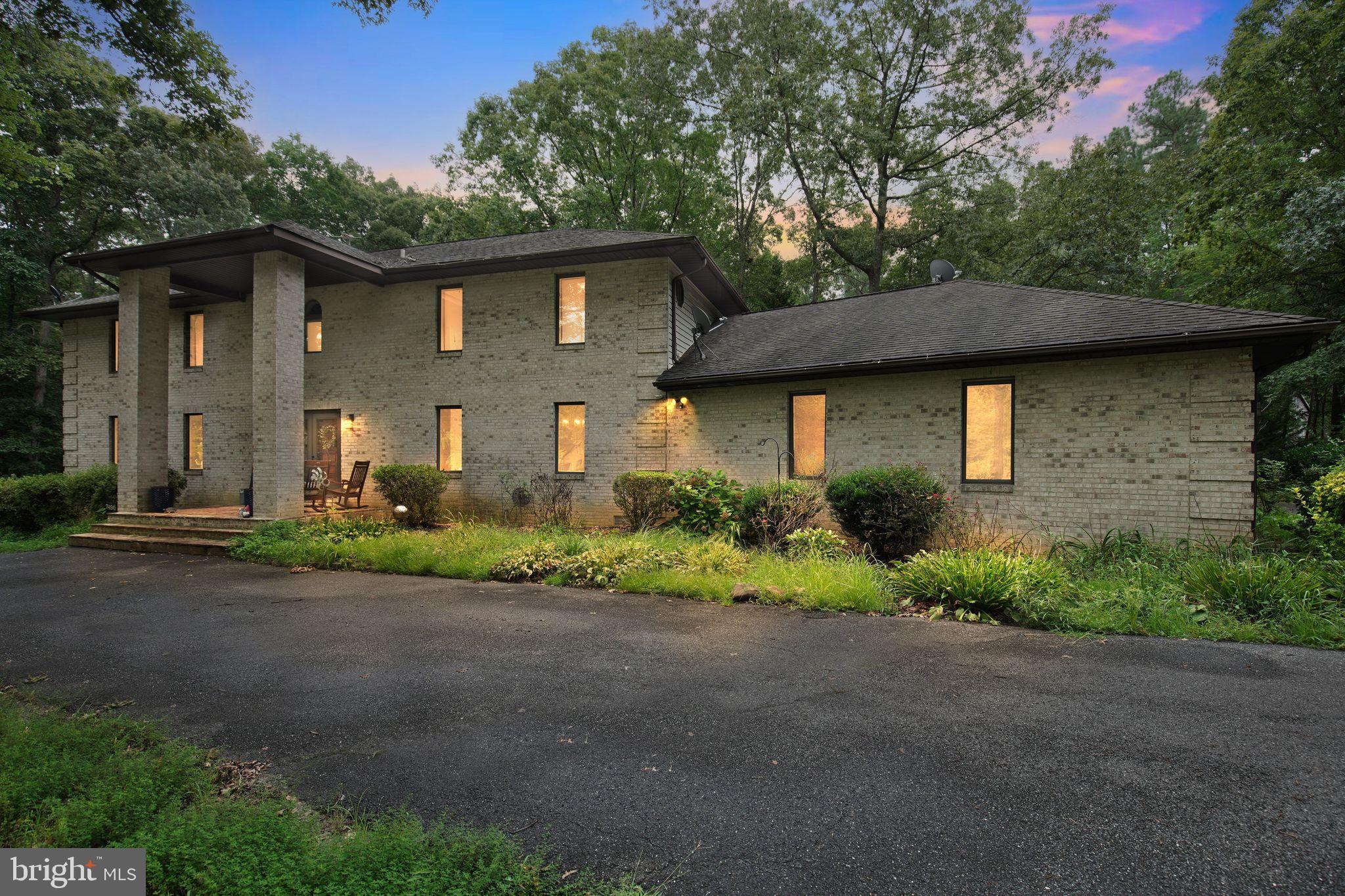 Spacious and elegant all-brick home situated on 3 private acres with no HOA! This stunning 5-bedroom, 4.5-bath residence offers exceptional living space and flexibility, perfect for a variety of lifestyles. The main level features 10 generously sized rooms, including a formal foyer, formal living room, parlor/library, and a main-level bedroom with en-suite bath and walk-in closet. The kitchen boasts a large center island, perfect for gatherings and meal prep, and opens to a welcoming family room with a beautiful stone fireplace. A spacious 25x25 recreation room provides endless possibilities for entertainment or relaxation. Upstairs, you'll find four additional bedrooms, each with walk-in closets, and three full bathrooms. A detached 3-car garage adds to the property's functionality and charm. Enjoy peaceful, private living just minutes from modern conveniences.