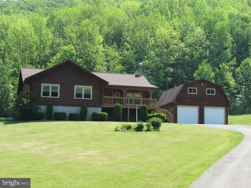 Spacious 3 bedroom ranch style log house on 22.79 acres of mostly wooded land, just 4 miles east of Covington. Large family room with gas stove, basement rec room, large rear deck, covered front porch with nice view. Detached 26x26 two story log garage.